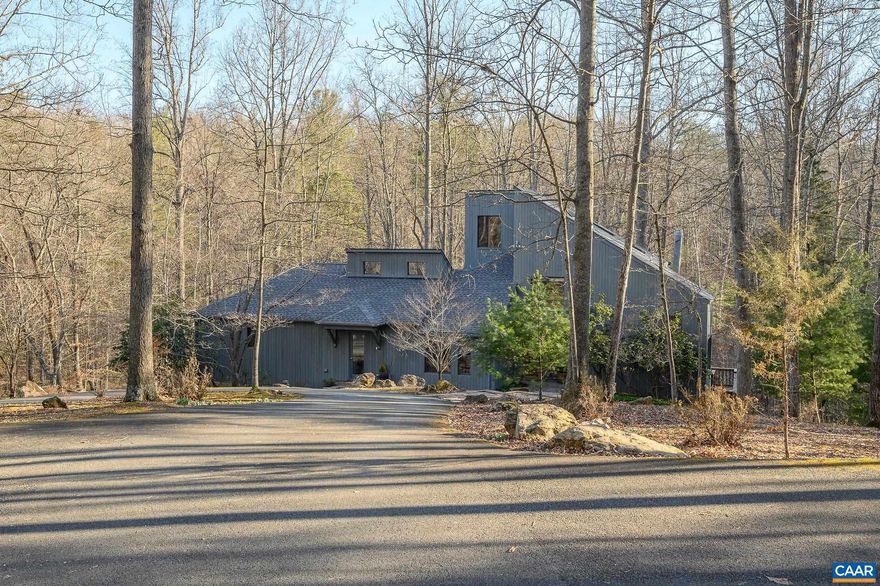 Experience contemporary living in this renovated architecturally designed Shank and Gray home situated on over 7 private acres in Ivy. Each room is a testament to custom craftsmanship, featuring wood plank ceilings, exposed beams and vaulted ceilings with skylights that bathe the interiors in natural light. The open floor plan includes a great room with hand built stone fireplace, window seat and built-ins which seamlessly leads to the den, dining room, eat-in kitchen and the family room. The FIRST FLOOR PRIMARY SUITE with Vermont Castings ceramic stove and two walk-in closets allows for one floor living. The primary bath enjoys a steam shower and jetted soaking tub. The terrace level serves as a home office, workout room or recreation area.  Upstairs, discover the original primary suite, two additional bedrooms and a whimsical loft. Recent updates include refinished hardwood floors, a new deck with propane line for the grill, modernized second floor bathrooms, 2 hot water heaters (2020), hpump 2022, gas furnace 2013 and Whole House generator 2018.  This home is a blend of style and functionality.  Immerse yourself in a property where every space invites you in!,Painted Cabinets,Solid Surface Counter,White Cabinets,Wood Cabinets,Fireplace in Great Room