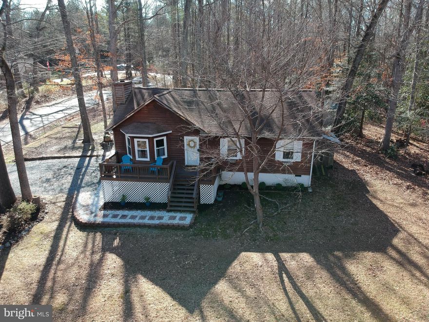 This move-in ready beautiful rambler is situated on a large water view corner lot in amenity filled Lake Caroline! This home boasts hardwood floors throughout, vaulted ceilings, gas fireplace w/ custom mantel, a welcoming front porch and newer rear deck. The roof, hot water heater and HVAC have all been recently replaced.  Don't miss out on your chance to enjoy the lake this summer!