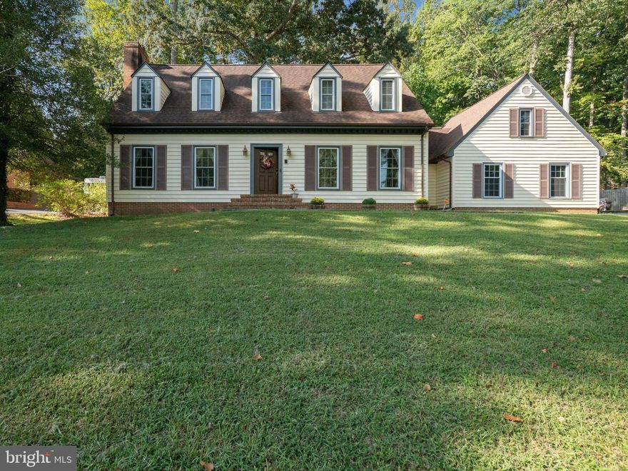 Welcome to the Quantico Creek Community of Graham Park Shores in close-in Triangle-- Minutes from Quantico Marine Base, I-95, and the Virginia Railroad Express! One of the few well-maintained neighborhoods that has NO HOA!!!  Lovely Cape Cod home features four large bedrooms and winter views of Quantico Creek through the trees across the street. BRAND NEW WINDOWS!! There are hardwood floors leading from the foyer to the kitchen. This kitchen has a wall oven, electric cooktop, and extra-large pantry. Detailed trim work adorns the staircase and there is crown molding throughout the dining room, living room, and family room. The family room has a built-in wet bar and stone fireplace. Luxury vinyl plank in the mud room and laundry room. There are three separate HVAC units for maximum efficiency, one of which is less than 2 years old.  The 2-car oversized garage has an automatic garage door opener and driveway parking for two additional cars. A large back patio offers a great space for outdoor entertaining in the private backyard. 
Enjoy Vacation at Home from now on with a Park Setting along with the Potomac & all of the wonderful amenities the Area has to offer -from World Class Shopping and Dining at Stonebridge Potomac Town Center, Wegmans, and Potomac Mills Mall. ideally located Just a Quick Drive away!! Less than 5 miles to the VRE, a Great Commuter Location. Easy Access to I95, RTE 1, MCB Quantico, Metro bus, Park n Ride, take VRE to Ft Belvoir & Pentagon and new DOD Facilities, or catch the Commuter Bus to DC. So close to Parks, Quantico hiking trails, and Quantico Creek!