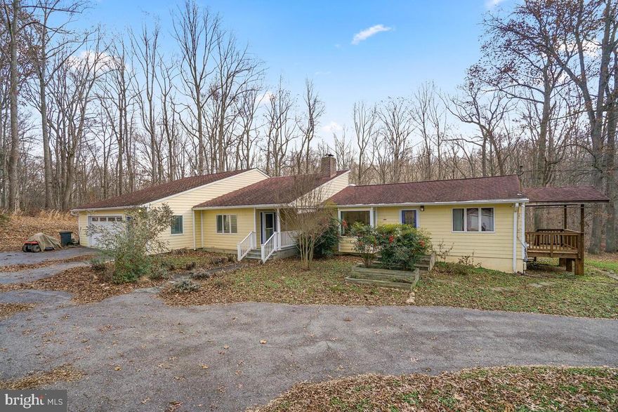 NATURE LOVER’S DREAM HOUSE. Follow a half-mile private driveway over the river and through the woods to find a prize at the end: a bright and beautiful contemporary rambler nestled on a property unlike any other in this area. The 4.5-acre lot is surrounded by hundreds of acres in the Hawlings River Valley Stream Park, offering you a locale that feels like a vacation home but is only minutes from the conveniences of Olney and an easy commute to DC. Enjoy the views from every room of this spacious home, which is centered around an open concept great room with soaring gallery-sized walls, strategically placed large windows, and adjoining dining room and kitchen/breakfast bar. The enormous main-level primary bedroom suite with tray ceiling features two walk-in closets and two bathrooms with radiant-heated floors connected by a shared large shower. Two additional bedrooms, a full bathroom with tub, a powder room, and an office and workshop space off the two-plus car garage round out the main floor footprint.  The owner extended the home in 2005 with an amazing master suite addition and extended the family room. The tax records are not correct and the living area is 2546 + SQF. Three wooden decks (one a whopping 975 square feet!), a greenhouse, and the mostly finished basement complete this one-of-a-kind home located just outside the town limits of historic Brookeville, Md.   "AS IS"