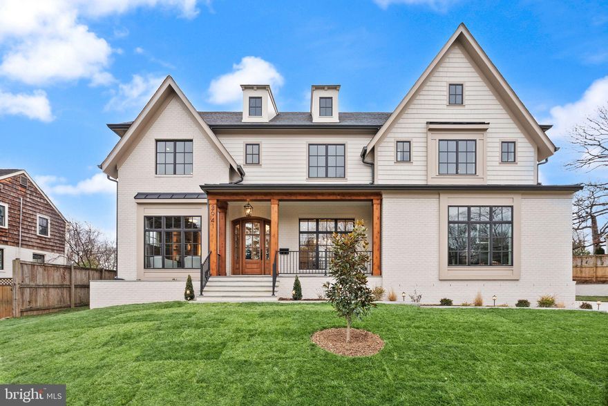 This exceptional new construction residence by PDB New Homes offers a rare opportunity to own a masterfully designed luxury home in sought-after North Arlington. Set on a 14,194-square-foot lot, this home delivers over 7,600 finished square feet of thoughtfully curated living space that seamlessly blends refined elegance with everyday livability.
Featuring 6 bedrooms, 6 full baths, and 2 half baths across three expansive levels, the home is designed to accommodate both gracious entertaining and comfortable daily living. A main-level bedroom suite with a full bath and walk-in closet provides ideal flexibility for guests.
At the heart of the home, the showcase gourmet kitchen impresses with a large island, custom cabinetry, walk-in pantry, and Wolf and Subzero Appliances. A separate breakfast room opens to the rear patio, while the kitchen flows effortlessly into the inviting family room with a gas fireplace and access to the screened porch—perfect for keeping the home chef at the center of every gathering. The main level is completed by a private study with French doors, an elegant powder room, and a spacious mudroom with custom built-ins, bench seating, and laundry/dog wash station hookup.
Upstairs, the luxurious primary suite is a true retreat, featuring a coffee bar, a show-stopping custom walk-in closet, and a spa-inspired bath with double vanity, a frameless glass shower, and a freestanding soaking tub. Three additional bedrooms—each with private en-suite baths and custom walk-in closets—along with a conveniently located laundry room complete the upper level.
The lower level is designed for entertainment and relaxation, offering an expansive recreation room with space for a media area and game room, a wet bar with seating, and a private bedroom suite ideal for guests or a second home office. A dedicated exercise room adds to the home’s exceptional functionality. Elevator shaft rough-in for all three levels.
Outdoor living is equally impressive with a three-season screened porch featuring a flagstone floor, ceiling fan, skylights, and heaters with access to the patio and private backyard—an ideal setting for hosting or unwinding.
Ideally located just minutes from Arlington’s premier shops, dining, parks, and entertainment. Less than one mile to GW Parkway and Washington Golf & Country Club, only two stoplights to Washington, DC, and just a quarter mile from Glebe Road Park and Gulf Branch Nature Center with scenic trails and tennis, pickleball, and basketball courts. Zoned for Jamestown ES, Williamsburg MS, and Yorktown HS.