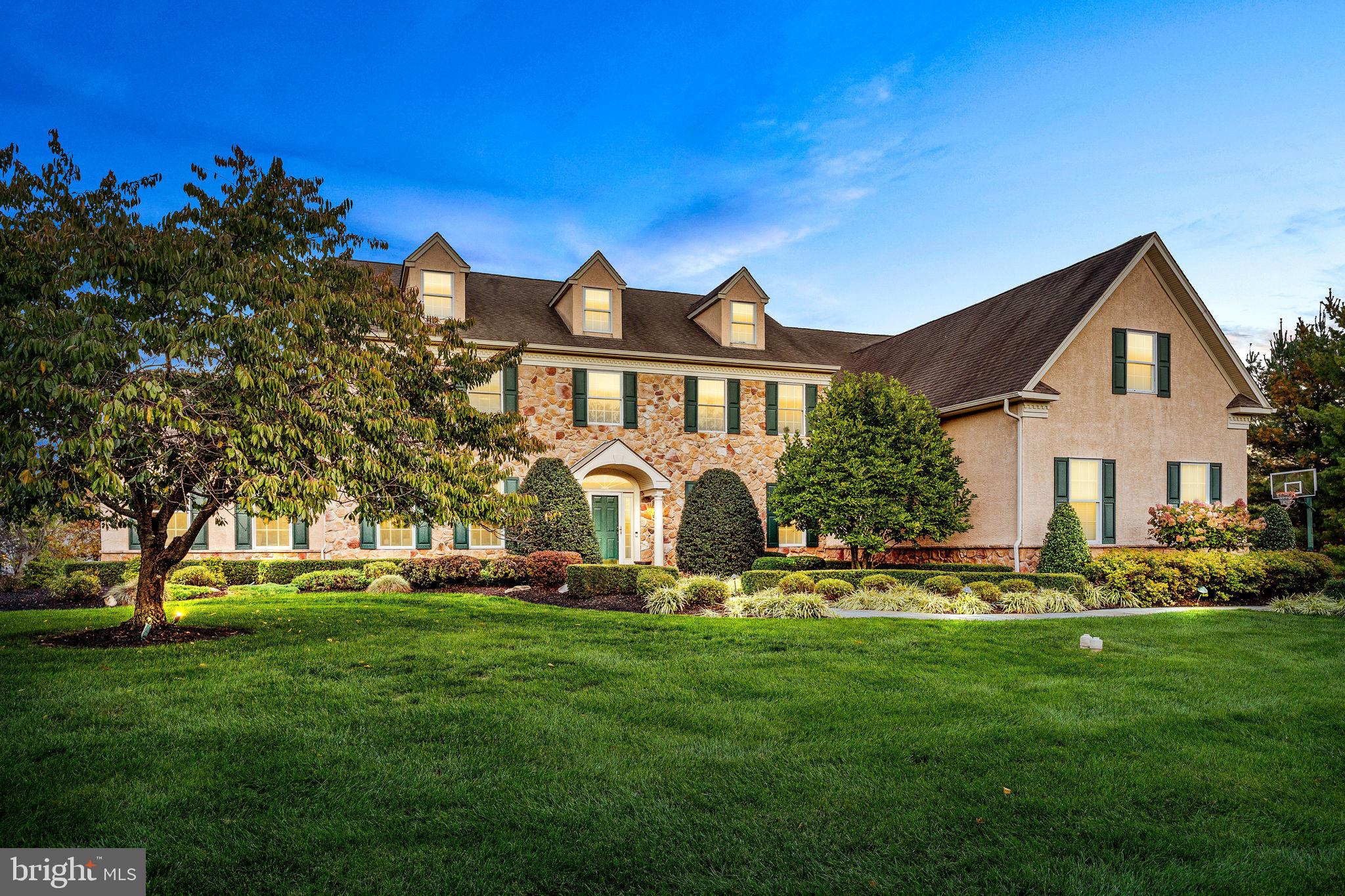 Stately Center Hall Colonial in prestigious Bucks County and Pennsbury School District. This classic and elegant stone front home has amazing curb appeal, is 5,700 square feet, and is positioned on 1 acre of picturesque grounds. The yard is professionally landscaped and offers much privacy between neighbors. Decorative slate walkway from driveway to front door with sidelights and portico. Added nine years ago and my favorite room in the house is an extraordinary open-air outdoor covered porch with slate floor, stone fireplace flanked by decorative columns, built-in kitchen amenities, stained oak ceiling, overhead fans, recessed lighting, and wired for surround sound. Step off the exquisite porch onto more slate designed for additional entertaining. The two-story foyer has a classic butterfly staircase with hardwood floors running throughout most of the first floor. Decorative wood moldings to include ceiling, chair rail, and picture frame gives the home a more stylish look. Adjacent to the center hall is the oversized formal dining room with tasteful faux painted ceiling and spacious living room which allows entry through beautiful glass French doors with transom window into the cozy Conservatory having many more windows, cathedral ceiling, and inlaid carpeting. The kitchen is of considerable size with plenty of 42” wood cabinetry, walk-in pantry, granite counters, tiled backsplash, stainless steel appliances, center island with overhead lighting, breakfast and sitting area and back stairs. Well positioned Butler’s pantry /bar area off kitchen. Two-stories continue into the family room and separated from front foyer by second floor bridge at top of center staircase. Focal point is the floor to ceiling stone fireplace flanked with arched windows making this room striking in appearance. Also are skylights in the vaulted ceiling. First floor office overlooks back yard. Powder room and laundry room with wash sink, cabinetry and countertop has side-door to porch completes this level. Upstairs is the Master bedroom suite with sitting room, huge walk-in closet, trayed ceiling with recessed lighting, and spacious master bathroom with deep soaking jetted tub, his and her vanity, shower stall, and separate toilet area. Three additional bedrooms with double closets and recessed lighting and two full bathrooms; one Jack-n-Jill and one princess.
Full walk-out basement is poured concrete with extra height, steel beam construction, updated high efficiency gas furnaces, and 200-amp electrical service. Three-car garage. You will fall in love instantly.