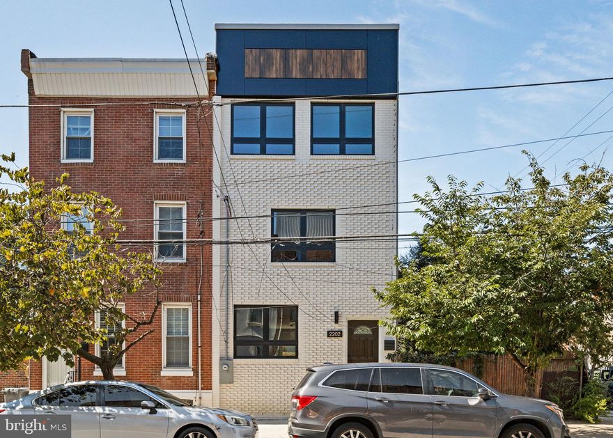 This stunning three-story home combines contemporary design with practical luxury, offering the ideal blend of comfort and convenience with 2257 square feet of living space and a 10 year tax abatement located in the Fishtown/Old Richmond neighborhood.  The first floor welcomes you with an open-concept living and dining area, flooded with natural light. The sleek, modern kitchen features quartz countertops, crisp white cabinets with black hardware. Step through the large sliding door to your private rear patio, ideal for outdoor gatherings and relaxing evenings. Upstairs, you'll find two generously sized bedrooms, each with its own luxurious en suite bathroom, providing perfect privacy and comfort. The third floor is your sanctuary an expansive primary suite with a massive walk-in closet and a spa-inspired bathroom featuring a soaking tub, large shower, and dual vanity sinks for everyday indulgence. Assend to the roofdeck, offering stunning city views perfect for sunset cocktails or morning coffee. The versatile basement includes extra space for a home gym, entertainment lounge, or second living area, along with a separate room ideal for a fourth bedroom and an additional full bathroom. You will benefit from a 10-year tax abatement and enjoy the walkable neighborhood close to Frankford Avenue’s thriving dining, shopping, and entertainment scene. This is more than a home it's a lifestyle, designed for the buyer ready to embrace all that Fishtown has to offer.