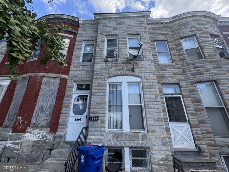Spacious three bedroom all brick townhome in convenient location. Open main level floor plan with hardwood flooring. The home features a huge covered back porch. Plenty of street parking and great access via the rear alley. Unfinished basement is ready for imagination.