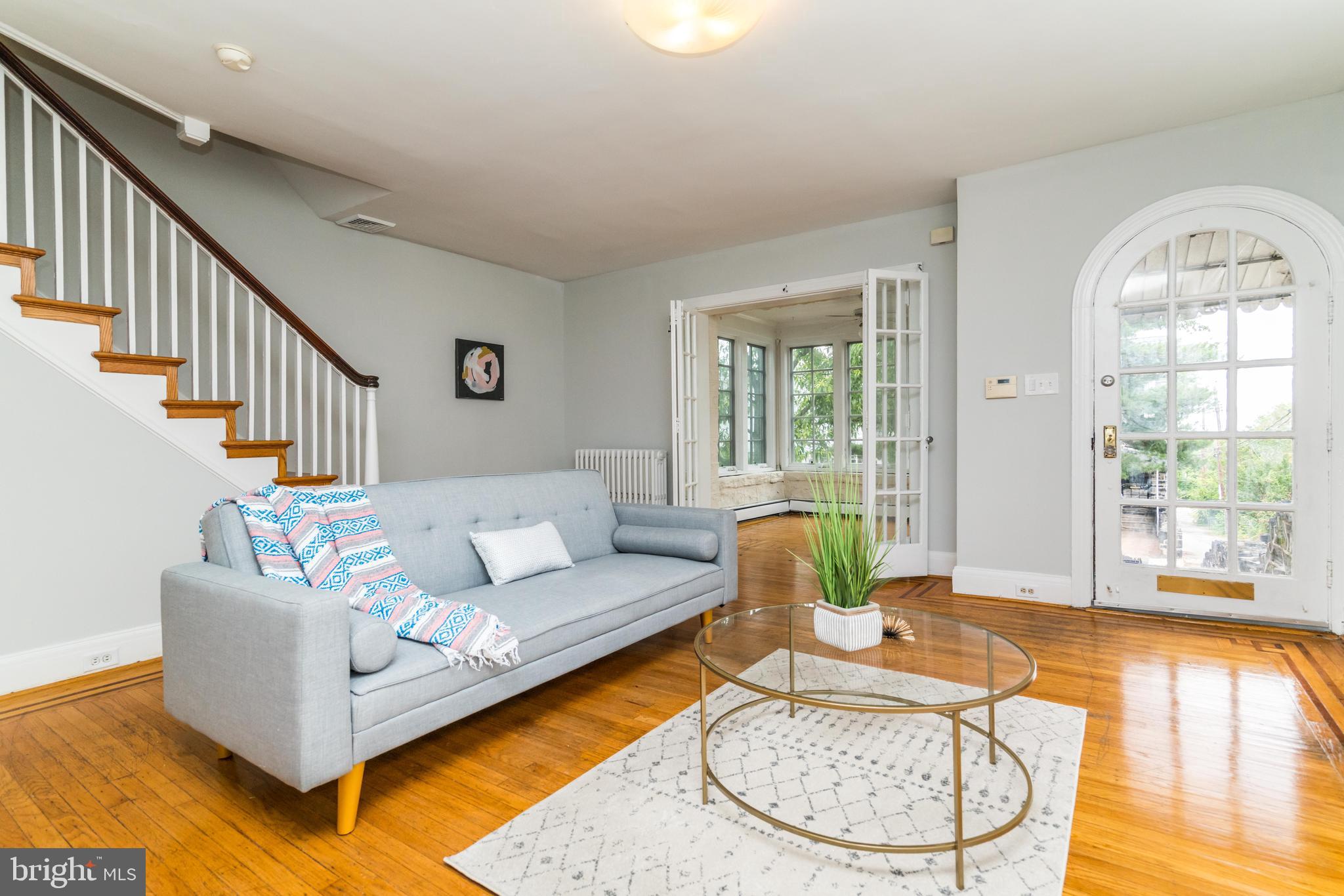 Welcome to this truly STUNNING - END OF GROUP- Ednor Gardens home - OVER 2000 SQ FT! This Stone-home sits high on the hill and has beautiful side windows which let in TONS of natural light. You'll love the gorgeous original hardwood floors with beautiful, original inlays - full of character and charm. Enjoy a gorgeous front sun-room with french doors and windows all around, a blown-out custom kitchen with breakfast bar, SS appliances and all new cabinets, 3 FULL BATHROOMS, a fully finished basement that could be used as a rental or in-law suite (it has a private entrance and kitchen - not licensed) Other amazing amenities include, CENTRAL AC, GARAGE parking - fit one car in the garage and there is a driveway for a second car, beautiful deck right off of the kitchen, Washer and Dryer on the main level, Huge Master Bedroom with WALK-IN CLOSET, 2 other spacious bedrooms upstairs all located on a scenic and quiet tree-lined street. Don't miss this gem!
