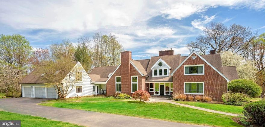 Presenting the happiest, most stylish home and barn property in Unionville! With a classic brick and cedar exterior, NEW windows,  bluestone walkways, porches and patios, the 6000+ square feet of living space is warmed with hardwood floors and beamed ceilings.  One of the highlights has to be the Terrain-inspired greenhouse room with cork wall and radiant heat tile flooring. The dry sink serves equally well as a beverage center or potting bench. The bright and airy kitchen features stainless steel appliances, including a gas cooktop and dual ovens. Butcher Block counters are easily maintained and perfect for doing homework at the kitchen island or food prep.  The adjacent cork-floored mudroom with multiple pantries and closets keeps clutter at bay. Throughout the first floor,  french doors and large windows bring the outdoors in. Every room enjoys views of nature and many have access to the outdoor patios and koi pond.  The living room has two focal points - windows and french doors opening to the patio and the bold brick fireplace wall. The living room flows into the adjacent dining room, also with french doors to the patio, making entertaining and guest movement seamless. The main-floor primary bedroom features a tiled fireplace,  en-suite bath with soaking tub, a walk-in closet and french doors to a private patio overlooking the meadow and woods beyond. A large laundry room buffers the second bedroom and en-suite bath, perfect for a nanny or in-law . The new owners will enjoy the family room with extensive built-ins for books and artwork, a floor-to-ceiling fireplace plus a vaulted ceiling that glows at night with hidden lighting. Upstairs, the loft area is the hub from which 3 additional bedrooms, 2 full baths, a sitting room and home office exist. These multi-purpose rooms can serve many needs for the next owner. The car aficionado will be thrilled with the main garage, plus an underground garage, with space for a total of 6-8 vehicles - cars, tractors, boats or motorcycles. Above the main garage, a private stair leads to finished space which may be used for storage or perhaps additional living space. The options are endless - wood shop, yoga or art studio perhaps? The basement is partially finished, with a full bath, recreation and exercise spaces, plus plenty of room for storage. There are two doors to the outside for safe egress. The 2005 barn was smartly laid out by someone with experience. Sited for cross-breezes, ventilation makes for healthy animals - horses, goats, chickens welcomed.  Large sliding doors at each end can be opened or closed to control the flow. There are three matted stalls, each with lights and electric for fans, sliding doors to the aisle and classic dutch-doors to the outside overhang. A wash-stall and tack/feed room complete the first floor. Rubber tiles in the center aisle add quiet and safety to the space. Stairs to the loft allow for easy access to hay and other stored items. It’s fondly referred to as “Sage Barn,” both for its color as well as the wisdom and serenity one finds there. The three-board fenced pasture is picture-perfect. New energy-efficient windows and a new septic system allow the new owner to focus on more important tasks on their country property.  Located between West Chester and Kennett Square, with easy access to local shops, restaurants, and schools, this property is the ideal choice for those seeking a tranquil lifestyle in a convenient location. The nearby Brandywine River offers kayaking and fishing opportunities, Cheslen and Stroud preserves are havens for hiking and outdoor activities. Philadelphia International Airport is 30 miles away, Amtrak regional rail with service to Philadelphia and New York is 7 miles away. This unique and dynamic floorplan offers many options for the new owner, whether multi-generational, work-from-home or simply a second home getaway.  Top-ranked Unionville-Chadds Ford School District and 50% of Newlin total acreage  is conserved.