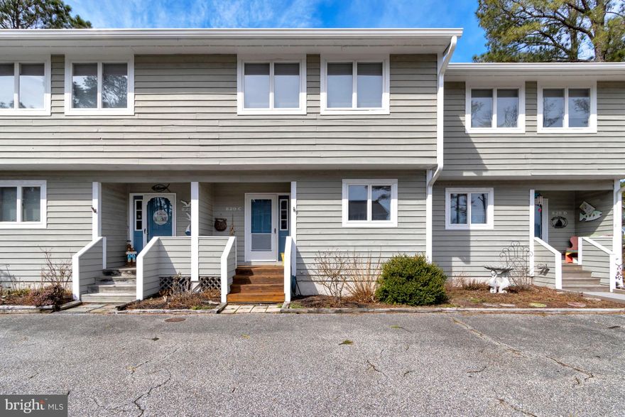 Located approximately one mile from Bethany Beach, this fully furnished townhome offers a convenient coastal setting in a quiet community. The front kitchen provides ample counter space and overlooks the dining and living areas, creating an open and inviting layout. Equipped with an electric stove and dishwasher, it offers convenience for everyday living and larger gatherings. A cozy breakfast nook in the kitchen provides the perfect spot to enjoy your morning coffee.  The main living area features a spacious living room with a wood-burning fireplace, ideal for chilly mornings, and an open dining area that allows plenty of room for entertaining. Just off the living room, a rear screened porch offers a relaxing place to unwind in the evenings while overlooking the backyard. An outdoor shower adds a practical touch for rinsing off beach sand before entering the porch after a day at the beach.  Upstairs, the home includes three bedrooms and two full bathrooms. The washer and dryer are conveniently located on the second floor, making laundry easily accessible. A powder room on the first floor adds additional convenience for guests. Beneath the staircase, there is flexible space that could be used for a wet bar, additional storage, or customized to suit your needs.   This well-located townhome combines comfort, practicality, and close proximity to the beach.