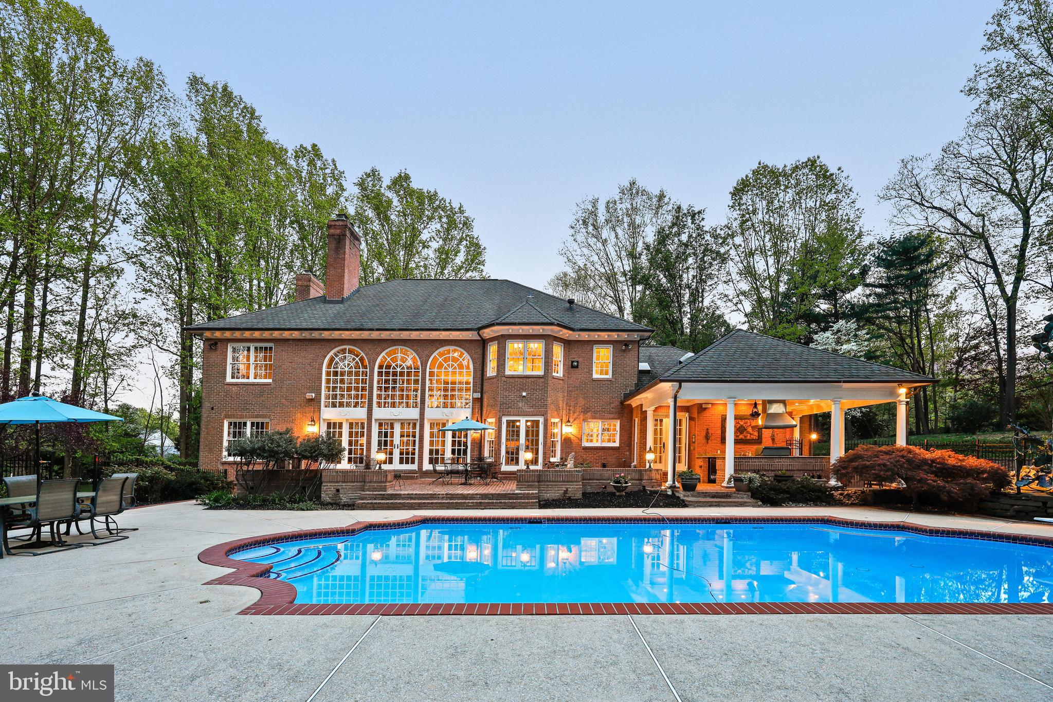 Welcome to 16 Chris Eliot Court, an exquisite residence where luxury meets functionality in every meticulously designed space. The heart of the home is the gourmet chef's kitchen, a masterpiece of practical elegance ideal for culinary enthusiasts. Step onto radiant heated ceramic floors and prepare meals using professional-grade appliances, including a Wolf gas range with a pot filler and dual ovens. Enjoy the sleek granite countertops, luxurious maple wood custom cabinetry from Kenwood Kitchens, and a host of sophisticated features such as a ceramic farmhouse sink, Sub Zero refrigeration, and an oversized kitchen island with a sink. The space is perfect for entertaining, with a bar and breakfast area, a walk-in butler's pantry, and an integrated desk area leading out to a stunning pool and balcony.
The home's charm extends to a splendid dining room where a wood-burning marble fireplace, rich hardwood floors, and crown molding create an inviting atmosphere for formal dining. The family room offers rustic elegance with a stone wood-burning fireplace, vaulted ceilings, and seamless outdoor pool and patio access. The professional home office boasts custom details like paneled ceilings and custom built-ins for your library collection. The luxurious primary bedroom suite features a gas fireplace, plush carpet, and recessed lighting, providing a soft, adjustable ambiance. The primary bathroom is a true retreat with marble flooring, dual walk-in luxury closets, an additional gas fireplace, a steam generator shower, and a relaxing Jacuzzi tub.
Each level of this home adds comfort and luxury, from soundproofed recreational rooms to a fully equipped lower-level kitchen and game room. The outdoor spaces are equally impressive, featuring a gourmet kitchen with a Weber grill, granite countertops, and a Wolf exhaust fan, complemented by an in-ground pool with a waterfall, a serene koi pond, and expansive grounds backing onto Oregon Ridge Park. This home offers an elegant living environment and includes thoughtful features like bathroom heaters, closet auto lights, and a comprehensive entertainment system, ensuring that 16 Chris Eliot Court is more than just a residence—it's a haven for sophisticated living.