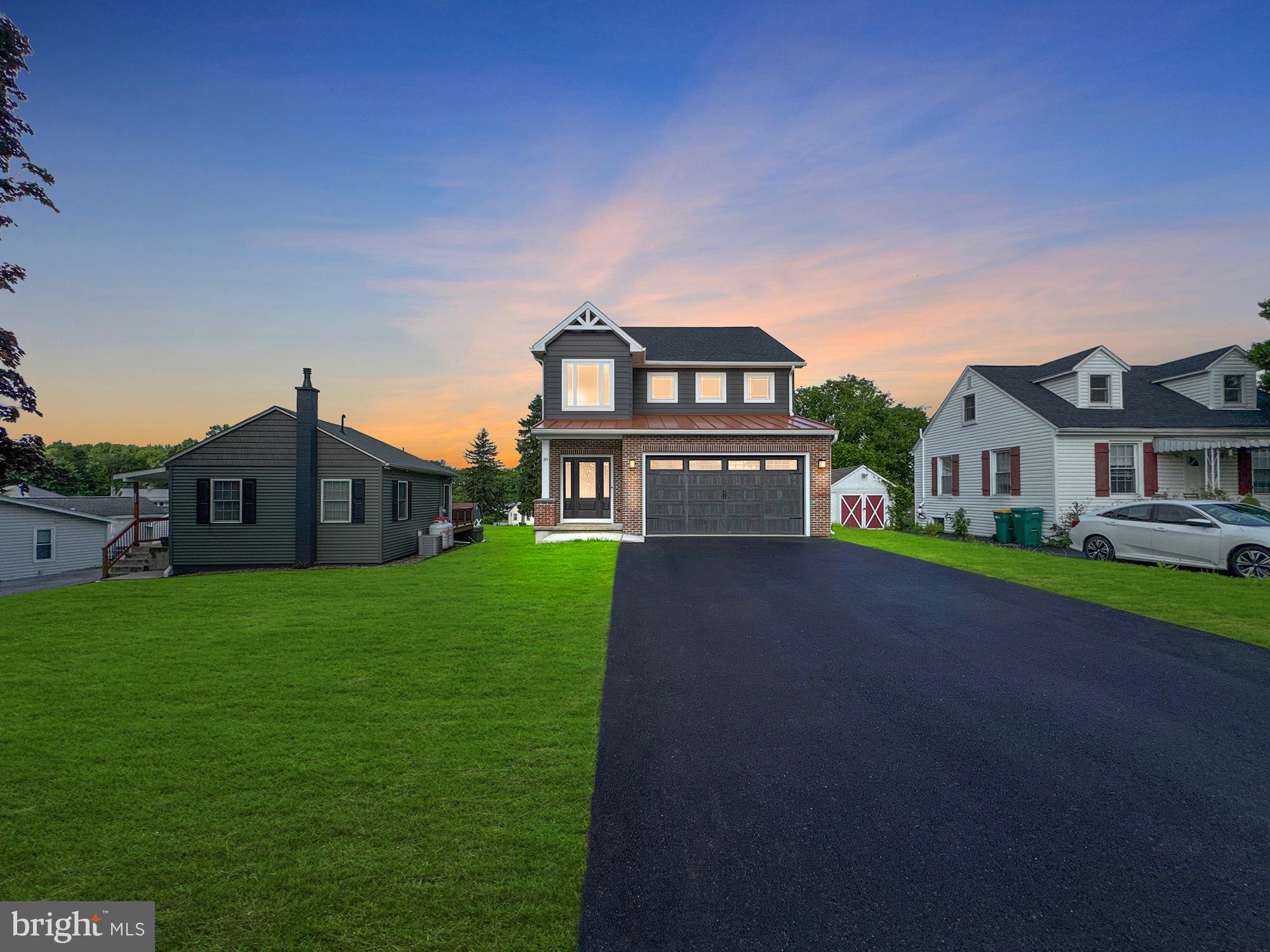 Step into elegance at 38 Kenwood Ave, a stunning new-build showcasing 4 bedrooms, 3 full baths, and over 2,200 square feet of refined living space. From the moment you walk through the front door, you’re greeted by 18-foot ceilings and a bright, open foyer adorned with oversized wainscoting, solid-core doors, and ¾” rustic Ash hardwood floors that flow throughout the main level. The heart of the home features a kitchen with semi custom soft close drawers, striking granite countertops, a tile backsplash, and an abundance of cabinetry. The open-concept design seamlessly connects the kitchen to the living area, highlighted by a tray ceiling, detailed trimwork, and abundant natural light. The primary suite is a luxurious retreat, complete with an illuminated tray ceiling, high-end carpeting, and a spa-like bath featuring a double vanity with granite, custom tile walk-in shower, and private water closet. Throughout the home, thoughtful upgrades include soundproofed interior walls, high-efficiency Bosch 20 SEER electric furnace, higher-end windows, and a standing seam metal accent roof for architectural flair and durability. Outdoor living is just as impressive, with an expanded 18x12 composite deck crafted with tongue-and-groove PVC flooring and aluminum railings, offering a private space to relax or entertain. The epoxy-coated garage floor and full unfinished 9' ceiling basement provide both function and future potential. Tucked into a quiet neighborhood, this home is also just minutes from major amenities—under 0.5 miles to Seven Gables Park, I-81, and Carlisle Airport, and just 1.2 miles from charming downtown Carlisle.