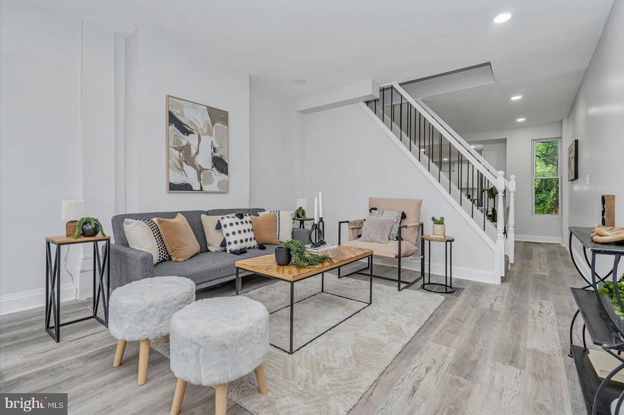 Transformed 3BR/2BA traditional Baltimore townhome located in the Oliver neighborhood. Step inside an amazing main floor boasting tons of natural light, a soft color palette, luxury flooring, recessed lighting, and the exposed brick wall which beams with original character. The large living room offers a view of the open concept dining room and kitchen.  The kitchen boasts plenty of cabinets, stainless steel appliances, granite countertops with a subway tiled backsplash, and a stainless sink under the window.  The newly carpeted second floor features a spacious secondary bedroom with a private en suite boasting a beautifully tiled walk-in shower and a vessel sink vanity. In addition, the large primary offers tons of light, a large closet, and a private en suite with a vessel sink vanity.  The lower level offers additional living space with luxury flooring, a spacious family room, a possible third bedroom or home office, laundry, and storage.  From the kitchen step outside to a wood deck ideal for a grill that overlooks the newly fenced yard offering tons of possibilities.  This home is move-in ready with so much to offer new homeowners including new windows and HVAC. Imagine all this and in close proximity to shopping, restaurants, and commuter routes.