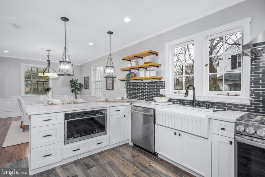 Own a piece of Real Estate in one of Baltimore City's best historic neighborhoods. Nicely restored while maintaining the original character of the house. Restored wood floor throughout,  No carpet anywhere. Master suite with an ensuite bathroom and a walk-in closet. The basement with tile floors has a living area, two rooms, a bathroom, and a second kitchen, allowing for multigenerational living. Two set of laundry hookups. This will not last. Easy to show