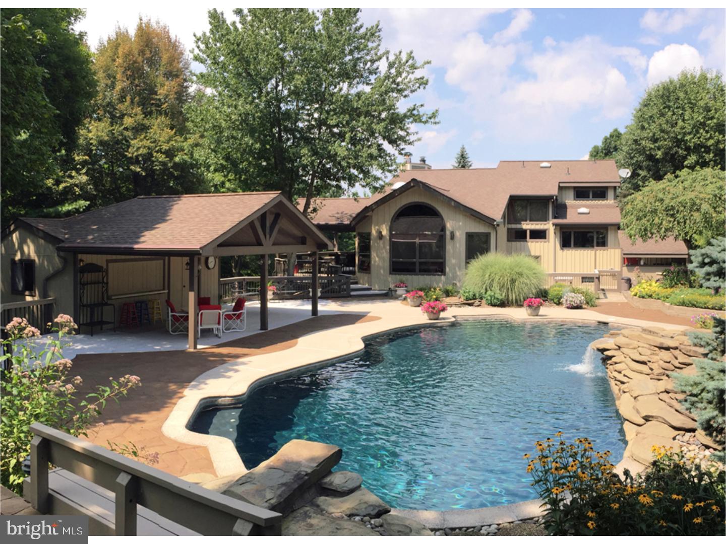 Serene, secluded and sublime? a most distinctive western rustic contemporary. This two-story hillside home offers all of the aforementioned and more. Nestled on two adjacent four-plus acre lots, this unique, private oasis boasts both inside and outside features that set it apart. Each has been designed to create the perfect functional, visual, and enjoyable place to call home. As you enter the home's interior, you will feel you're inside a Rocky Mountain chalet. This customized treasure looks as great today, as it did when first constructed in 1978. Dramatic open beams highlight the foyer. The tongue-and-grooved walls and ceiling work in a very complementary fashion. Tasteful, decorative finishes; upgraded mood lighting and artistic touches (many hand-created by the owners) are tastefully positioned throughout. The kitchen highlighted by shaker style hickory cabinets with Corian countertops creates a cook's dream, topped-off by high-end appliances. The family room has open-beamed ceilings, along with a wonderful and inviting fireplace. The great room (with a vaulted ceiling) offers abundant natural light. With major renovations and upgrades in 2001, the open concept floor plan offers myriad options to transform each space. Currently configured with three bedrooms, two full baths, and a lower level powder room, the possibilities for customization are limited only by your imagination. The spacious ground level boasts an Artist's Studio and garage that could become a versatile entertainment space, or even function as a home office/business especially with the established high speed internet connection. The area could also be easily converted into a private entrance in-law apartment. Outside amenities include an in-ground swimming pool with waterfall, fully outfitted cabana, kennel/fenced-in yard, terraced gardens, and a sizable covered porch.