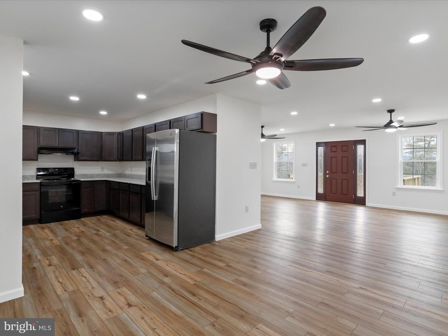 MOTIVATED SELLER!
Welcome to your own private retreat, with this 2025 new built home.  Nestled in the
serene beauty of nature, this stunning country home sits on 3.29 private, wooded acres.
It offers the serenity of nature and space to explore.  The expansive mountain view &
open sky is inviting you to country living. It is a peaceful retreat from the hustle of
everyday life. The dining, living/family area is comfortable for time with family and
guests.  Numerous windows bring in natures light and showcase the surrounding
natural environment.   A spacious "U" shaped kitchen boasts stainless steel appliances,
granite countertops and an abundance of cabinetry.  Stainless steel sink with whole
house water filtration system and purified drinking water with reverse osmosis faucet for
delicious drinking water.   
The home features five bedrooms and four beautifully appointed bathrooms,
thoughtfully designed to accommodate family and guests in comfort.  On the 1800
square foot main level there are three bedrooms. Additionally, there are two spacious
owners' suites, one on the main level and the other in the fully finished 1800 square foot
lower level walk-out basement. The rest of the basement space is open and provides a
lovely canvas for the new owners to exercise their creativity.  In-law suite, Air BnB,
Guest suite, Game room, rent it out or whatever you like.  Practicality meets
convenience with two laundry rooms, one on each level, making day to day living
effortless for large families or multigenerational living.  
All rooms have remote controlled ceiling fans.  Central air-conditioning and heat pump
provide the home's indoor climate control. 
The exterior features a 12 x 16 deck front entry, and a full length covered back porch. 
The 400-amp electric service makes expansion trouble free.  The property is secluded
with privacy, yet close enough to town to not feel isolated. 
This is more than just a house: it's a lifestyle, where privacy, comfort and natural beauty
come together in perfect harmony.