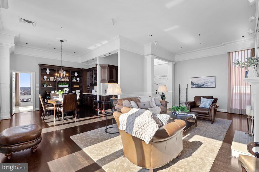 Breathtaking completely remodeled high-rise penthouse in The Towers at Harbor Court with unparalleled panoramic views stretching from the Chesapeake to the City Skyline and beyond. This two bedroom, two and a half bath condo offers 1920 square feet of freshly painted, completely remodeled, elegant living space. With a warm greeting from the doorman, step inside the luxe, marbled lobby and make your way to the high-speed elevators. A 40-second ride brings you directly to the private lobby, recently renovated with sophisticated millwork trim, decorative ceiling, high-end carpet, and custom lighting. The living room boasts a wood-burning fireplace, built-in shelving, Bose surround sound, and timeless cornice molding. A breakfast bar between the living and dining rooms is the perfect spot to enjoy morning coffee and take in the harbor views. The dining room features wrap-around display shelving and an entertainer’s wet bar complete with wine refrigerator and wine rack.

The chef’s kitchen is well-appointed with quartz countertops, stainless steel appliances, limestone flooring, rich espresso cabinetry, and a cozy breakfast nook with a Southern horizon view. The primary suite features cove lighting, cornice crown molding, and a spa-like bathroom with a glass shower with bench. The second bedroom is ensuite, offering privacy and ample space for guests. A convenient laundry center and powder room complete the living space.

This top-floor unit offers sweeping skyline views, creating a peaceful and private retreat in the heart of the city. With no residence above, the unit ensures comfortable and energy-efficient living. This unit also comes with one deeded parking space and one deeded storage unit, and additional parking spots are available to rent.

Residents of The Towers at Harbor Court have access to a private community room with a kitchen available to rent, a two-bedroom condo available for guest use, and a private park-like courtyard with a gazebo. The recreation fee provides access to facilities at the Royal Sonesta Baltimore, including an indoor pool, hot tub, fitness room, racquetball court, sauna, spa services, and more.

Nearby, enjoy the Harbor Promenade, West Shore Park, Federal Hill Park, and the Maryland Visitor's and Science Centers. Take an easy walk to many of Baltimore’s most well-known spots for dining, shopping, and nightlife. Sports fans will especially enjoy the short walk to the stadiums.

With so much to see and do, there's no better place to call home than this incomparable luxury high-rise penthouse in the heart of Baltimore's Inner Harbor.