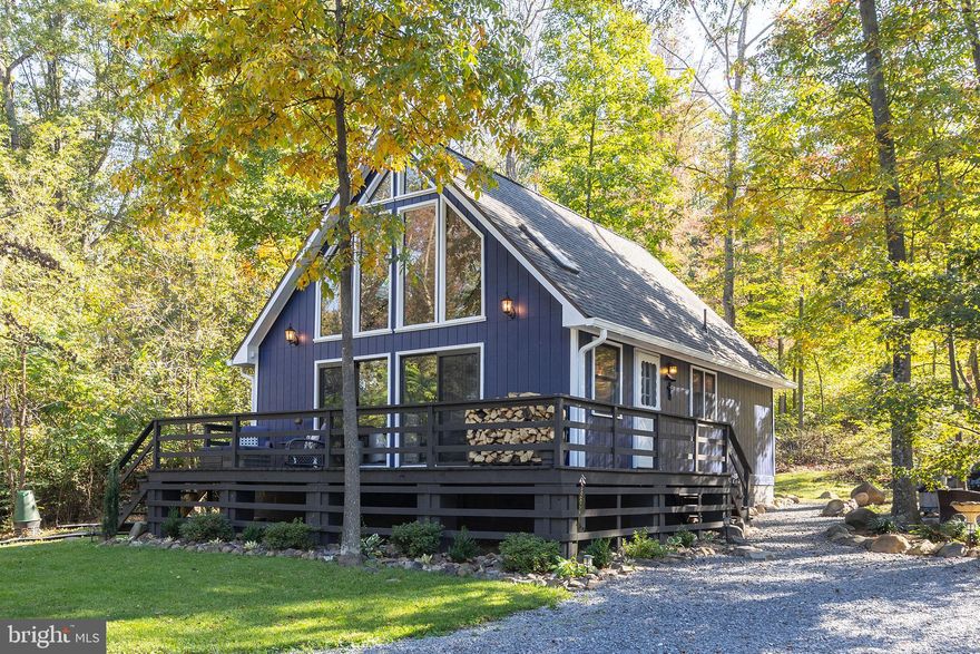 Escape to your own private retreat in rural Hampshire County, WV!   Nestled on 10 acres of usable land, this beautifully updated 2-bedroom (one being the loft), 2-bath modern chalet blends contemporary design with rustic charm. Surrounded by woods with pockets of open ground in front, it’s the perfect mix of privacy and practicality. Step inside to find a bright, open-concept living area anchored by a cozy wood stove, sleek finishes, and modern updates throughout. Enjoy peaceful mornings on the deck or evenings by the fire while soaking in the natural beauty around you. A large pole building, huge shed, and wood shed offer abundant space for storage, hobbies, or a workshop.  Most everything has been updated over the past few years.  Whether you're looking for a full-time home or a serene getaway that you can short term rent, this property delivers the ideal balance of comfort, style, and rural tranquility.  Don't delay in visiting this amazing property soon!  This one is going to attract some attention!!