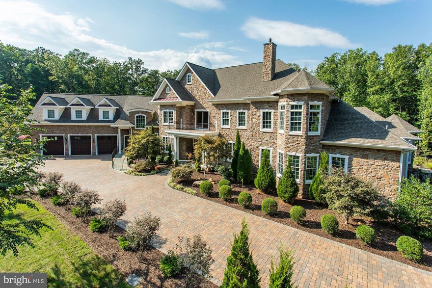 It is with great pride that we present this exquisite, beautifully appointed,   custom built executive  estate, perfect for year round entertainment possibilities for family, friend and business associates.  It is truly "One of a Kind" in style, quality and craftsmanship.  It IS "Your Forever Home"!   In addition to five bedrooms, including four en-suites with walk-in closets, the nearly 13,000 SF custom home includes: an indoor, heated swimming pool with cathedral ceilings, faux wood beams and floor-to-ceiling custom windows; a 3-Season screened solarium with access to the pool, main level, and expansive patio and backyard; a two-lane, regulation-size Brunswick Bowling Alley; and Home Theater/Media Room and Bar.  The 3-level home also features hand scraped, hardwood floors throughout, a large, gourmet kitchen with an expansive center island, large dining room, living room, several family living areas, seven bathrooms, four gas fireplaces, elevator, custom designed closets, security cameras, and a sophisticated security system.  Nearly three acres of the fenced-in ten+ acre property has been professionally designed with landscape and hardscape to blend seamlessly into the woods and trees beyond, including water access to the Occoquan River. The property is accessed securely via two wrought iron gates.Additional custom features include: Main level, open floor plan with state-of-the-art gourmet kitchen with commercial-grade Thermador appliances, including Range, Wall Oven and Microwave, built-in column style refrigerator and freezer; walk-in pantry, second refrigerator; granite countertops; porcelain farm-style sink and hammered copper bar sink; built-in Thermador column-style wine refrigerator; upgraded cabinetry, and a separate Eating Area with bay window .Main level also includes a Master Suite complete with an expansive walk-in  closet, with access to the patio and backyard; Second-Master Suite; Laundry room; Powder Room; Library with fireplace and built-ins; and, a Great Room that leads to a covered porch onto the large patio and gazebo area. The Upper level includes a family room with wet bar area, featuring a hammered copper sink, refrigerator, and upgraded cabinetry; covered Balcony overlooking the backyard; second laundry room, a second walk-out balcony that overlooks the front yard; and an expansive bonus room. The Lower Level includes an open Home Theater; custom bar with hammered copper sink, refrigerator, exotic granite and separate pub style seating; 2-lane regulation bowling alley; home gym with mirrored wall and cushioned, rubber flooring; full bath; and a craft / shop area complete with a full-size sink. The home was designed to Age in Place,  with features including, but not limited to: an access/egress ramp that integrates seamlessly with the hardscape; elevator, wide doorways, door-free walk-in showers; and lever-style door handles and faucets throughout. Added protection with a whole house Generac generator system. The home was built in 2014 by Mike Garcia Construction, Inc., Woodbridge, VA; Architectural Design by Sandhya Gorur, AIA, Another Angle Design, Centreville, VA; Interior Design by Lorna Gross, ASID, Lorna Gross Interior Design, Bethesda, MD.  The home was featured in the 2015 January / February issue of Home and Design Magazine.This is a spectacular property designed to complement and incorporate the surroundings, emphasizing the elements of wood, stone and light, and maximizing the views of nature with a nearly 360-degree view of the property grounds. It is perfect balance with quiet, wooded surroundings, incredible quality, and unlimited opportunities for entertaining family and friends, all the while being close to major transportation and everything that the Washington DC area has to offer.
