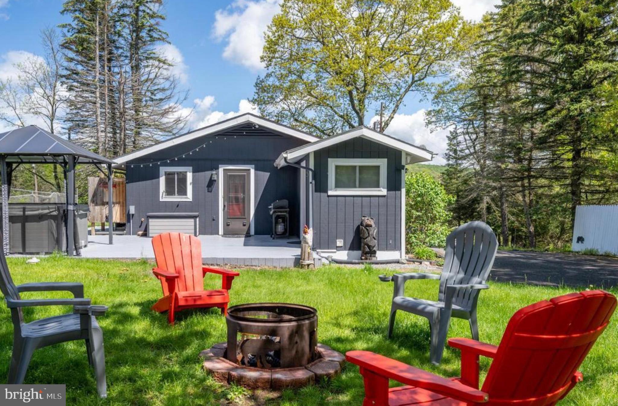 Tucked off the beaten path but minutes from Deep Creek’s best spots—this move-in-ready rental makes life easy. Well-kept and sold fully furnished. Packed with upgrades—new well drilled in 2024 with fresh liner, plus new pressure bladder, pump switch, and wiring. UV water treatment and softener in place. Most of the plumbing has been redone. Smart home features let you run the heat, AC, door lock, deck lights, and security camera—all from your phone. Cozy two-bedroom layout with gas fireplace and warm wood finishes. Soak under the stars in your private 5-person hot tub. No HOA, no hassle—just simple mountain living with modern updates and solid bones. Quiet, private, and set up for stress-free getaways or steady rental income. Call today for details!