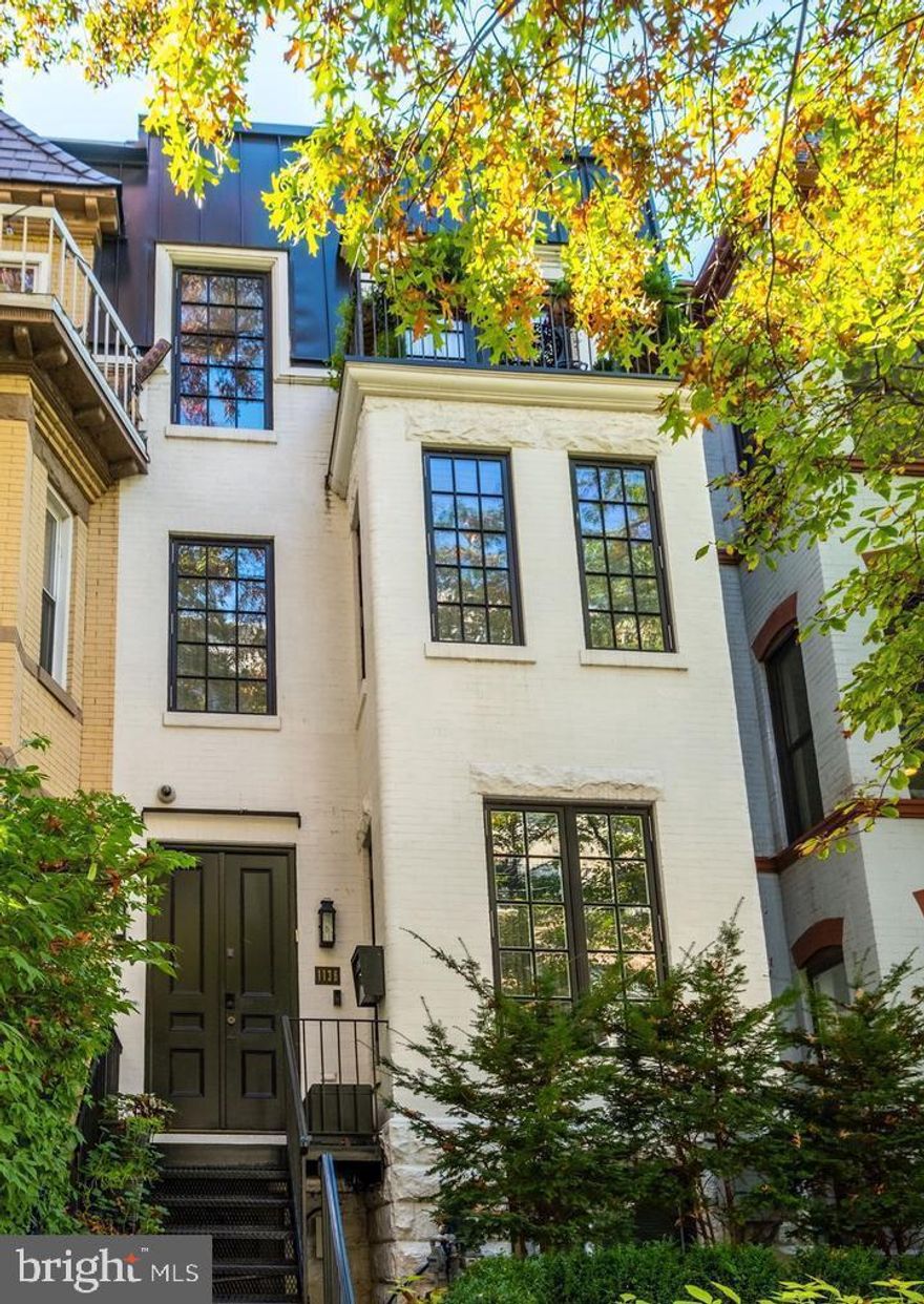 This captivating rowhouse graces a charming residential street, offering an unbeatable location that places the very essence of Washington right at its doorstep. Total home transformation in 2018 by acclaimed BOWA design build experts.  Boasting over 3,500 square feet, this stunning residence showcases a seamless blend of historic charm and modern luxury. 

Step inside to discover an impressive entry level featuring a dramatic living room with a fireplace, a spacious dining room, an exquisite half bath, and a well-appointed kitchen adorned with custom cabinets and high-end appliances. Sunlight pours in through a wall of French doors, inviting you to an expansive rear patio, perfect for outdoor living and accommodating multiple cars.

Ascending to the first upper level, the owner's suite takes center stage, offering a generously sized bedroom with a fireplace, an office nook, and a designer bathroom adorned with Waterworks fixtures, a steam shower, heated floors, and a freestanding bathtub. Custom closets with thoughtful details provide ample storage.

The second upper level houses an elegant office with custom shelving, two tastefully renovated bedrooms, two bathrooms, and a balcony adorned with lush plantings. A rooftop retreat awaits above, featuring a dining area, entertaining space with a fireplace, and a lounge area with remote-controlled louvers—an exceptional space for year-round enjoyment.

The lower level, accessible through a separate entrance, unveils a large bedroom, a high-end bathroom, a custom gym with a steam shower, a family room, and a laundry room. Abundant storage options, including a Subzero wine fridge with space for 150 bottles, complete this level.

With four meticulously finished floors showcasing top-tier craftsmanship, secure parking for up to four cars, and an elevator servicing each floor, including the rooftop oasis, this residence epitomizes the pinnacle of modern living. Welcome to a home where historic elegance meets contemporary sophistication. 

 Finishes and Remodel:
- Viking, Bosch and Wolf kitchen appliances including double ovens, grill, a warming drawer, and double dishwashers
- Full-size 150 bottle Viking wine fridge
- Two steam showers
- LG Styler Steam Closet
- Waterworks faucets and showers
- Lutron home automation lighting system
- Datawatch alarm system
- Trane HVAC split into three zones
- SunBriteTV outdoor TV
- Plumbed high-end grill
- Three indoor and one outdoor gas fireplaces
- Marble countertops
- Electrified remote controlled louvers for sunshade on the roof deck
- Whole house water softener and chlorine filter