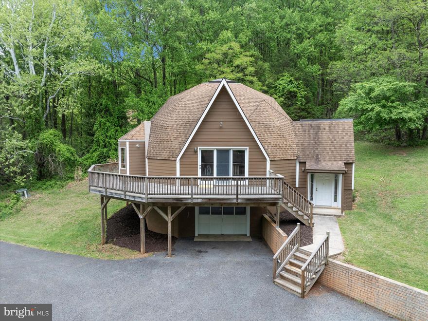 Nestled on a sprawling 6.35 acre lot, this Dome-style residence offers a unique blend of seclusion and comfort, perfect for those seeking an exclusive lifestyle. With a major renovation completed in 2026 that includes new carpet, windows, freshly painted throughout, new HVAC heat pump, and more! The open floor plan seamlessly connects the living and dining areas, enhanced by abundant natural light streaming through the bay window, as well as skylights. The updated kitchen features new  stainless steel appliances, a built-in range, and an inviting island. The breakfast area is a cozy spot to enjoy morning coffee, while the wood floors add a touch of timeless charm. This residence boasts three bedrooms and two full baths in the main house, including an entry-level bedroom for added convenience. In addition there is a fourth room for flex use as an office or den. The exterior of the property is equally impressive, with a wrap-around deck that invites you to bask in the serene surroundings. The partly wooded lot backs to trees, providing a sense of seclusion and tranquility. For equestrian enthusiasts, the property is equipped with horse amenities, including 14x48 (3 Stalls) stables and allowing you to indulge in your passion for horses right at home. Additional structures, such as a guest house and 10x20 shed, offer versatility for guests or extra storage. The one bedroom, full bath guest cottage features a living/dining area, kitchenette, basement storage and is separately metered, a plus for potential rental usage.The attached garage provides convenient access, while the expansive driveway accommodates multiple vehicles, ensuring ample parking for gatherings. With breathtaking mountain views and a private, secluded setting, this property is a true sanctuary. This home is not just a residence; it's a lifestyle. Experience the perfect blend of comfort, and nature in this remarkable property, where every detail has been crafted to create a warm and inviting atmosphere. Embrace the opportunity to make this exceptional home your own.

Photos coming soon!