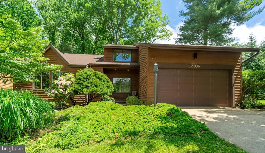 Tucked away on a quiet cul-de-sac, this beautifully maintained contemporary home offers three spacious levels of versatile living space, soaring ceilings, and expansive windows—including skylights that flood the home with natural light. Thoughtful updates blend seamlessly with timeless charm to create an inviting and functional sanctuary.

The main level features a stunning sunlit living room with vaulted ceilings and large windows, open to an upstairs overlook and adjacent to the formal dining room, where gleaming hardwood floors set a warm and elegant tone. The renovated kitchen is a chef’s dream, featuring quartz countertops, a marble tile backsplash, dark stainless steel appliances, built-in cherry inset cabinetry, an island, recessed lighting, new flooring, and a spacious walk-in pantry. A sunny breakfast nook with a large window offers a charming spot to enjoy your morning coffee with views of the backyard. Just off the kitchen, the spacious family room boasts hardwood floors, a cozy fireplace, and sliding glass doors that open to an expansive wood deck—perfect for dining al fresco or taking in the peaceful scenery of mature trees.  

Additionally, the main level offers a versatile bedroom that can serve as a home office, parlor, or guest room, along with a full bathroom and a laundry room for added convenience.

Upstairs, the expansive primary suite offers a peaceful retreat, featuring large windows, built-in shelving, a walk-in closet with attic access, and a spacious en suite bath complete with dual sinks, a soaking tub, and a separate shower. Three additional bedrooms are located on this level and share a well-appointed hall bath with dual vanities and a skylight that fills the space with natural light.

The walkout lower level—with its private rear entrance and full-size windows—adds exceptional versatility to the home. It includes a spacious recreation room, a sixth bedroom, a full bath, two oversized storage rooms, and a separate workshop area. Outfitted with newer LVP flooring throughout, this level is perfectly suited for multigenerational living or could easily be transformed into a full in-law suite or apartment with the simple addition of a kitchen.

Located in a sought-after Columbia neighborhood, the home offers access to an array of HOA amenities, including bike trails, walking and jogging paths, tennis courts, tot lots, common areas, a community center, and optional golf course membership.

This is more than just a house—it's a place to live, grow, and thrive. Don’t miss your opportunity to own a thoughtfully updated, light-filled home in one of Columbia’s most desirable communities.