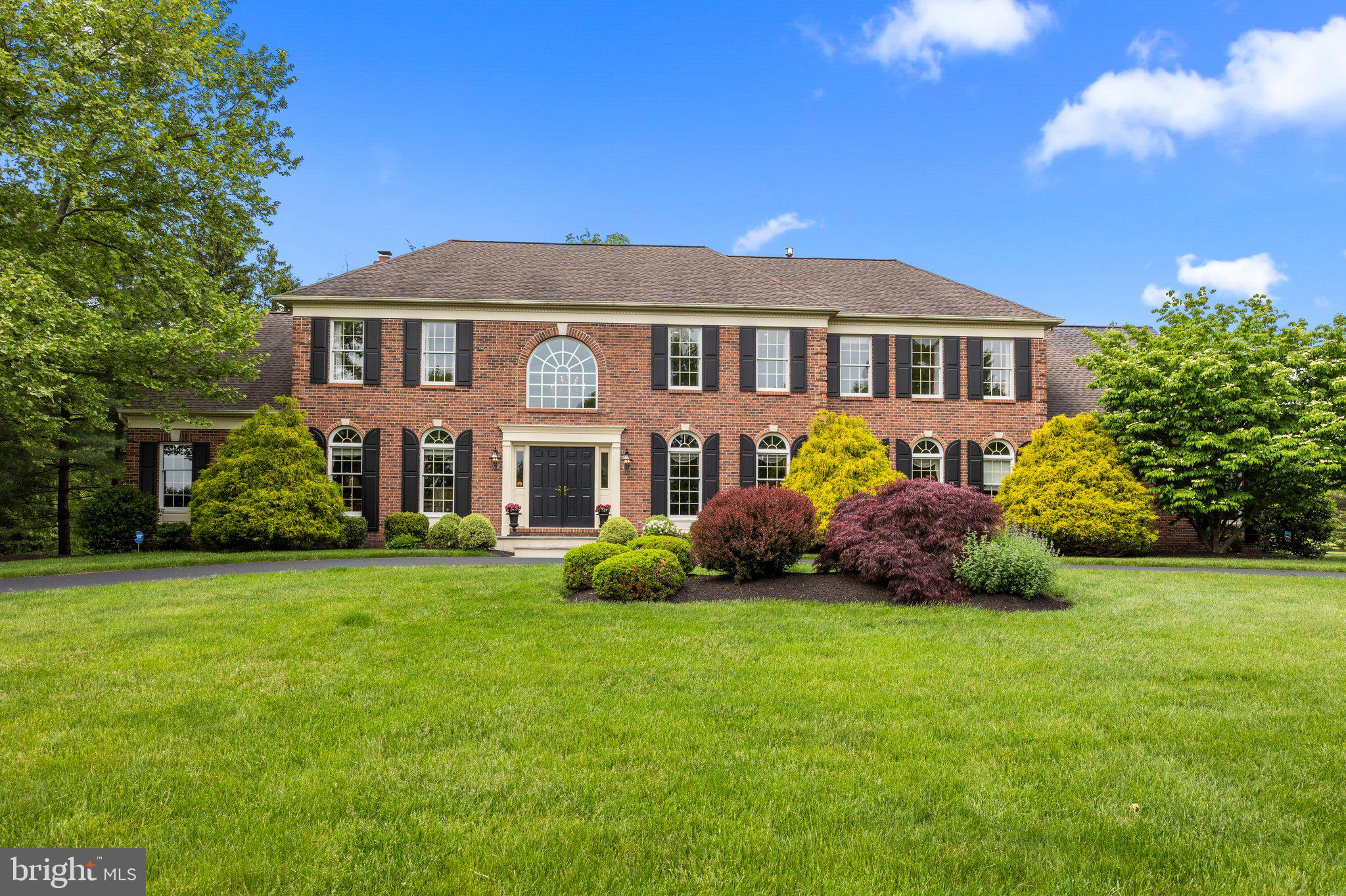 Welcome to 42 Woodside Ln, situated on a picturesque lot in the prestigious River Crossing neighborhood of Upper Makefield. This magnificent home offers a fabulous view of Bowmans Tower, providing a serene and private backdrop for luxurious living.
As you approach this brick-front beauty, you're greeted by a blue stone porch and double door entry that opens into a grand two-story foyer. The foyer, adorned with a curved staircase and open railings, elegantly divides the formal living and dining rooms, setting the tone for sophistication throughout.
The heart of the home is the updated gourmet kitchen, featuring a high-end appliance package that includes a 48-inch Viking refrigerator, double wall ovens, and a convenient microwave drawer nestled in the island. New hardwood flooring, Granite countertops, a stone backsplash highlighted by under-cabinet task lighting, and a large window over the sink add to the kitchen's allure. The spacious island comfortably accommodates seating for at least five, making it perfect for casual dining or entertaining. There is also a transitional space between the kitchen and family room that offers many potential uses for additional cabinetry or bar space. A walk in pantry is found directly off the kitchen and features built-in shelves.
Adjacent to the kitchen, the two-story breakfast room is bathed in natural light, while two sets of French doors open to a cozy and inviting sunroom. On the opposite side of the breakfast room, you'll find a versatile den/study, ideal for work or relaxation. The back staircase with an open railing provides easy access to the second floor bedrooms.
The family room is a fantastic space for gathering with loved ones or relaxing by the gas fireplace. On the side of the home you will find an additional solarium room which offers further options for leisure, recreation, and entertainment. Upstairs, take note of the gleaming hardwood flooring that stretches throughout the second level of the home. The impressive primary suite boasts a sitting room, two walk-in closets with organizers, a vanity area outside the bathroom, and a luxurious, updated bathroom with new tile, double bowl vanity, built-in storage, vaulted ceilings, and a large walk-in shower with a frameless glass enclosure.
Three additional bedrooms complete the upper level, including two that share a Jack-and-Jill bathroom, and another with its own en-suite bath and walk-in closet. Additional highlights include a three-car garage, an unfinished basement with abundant storage, whole house generator, and a Trex deck that overlooks the private backyard and tranquil woods.
This distinguished home offers over 5,300 square feet of above-grade living space, harmoniously blending elegance, comfort, and functionality in a coveted location. Located within the award winning Council Rock School District and within commuting distance to Princeton, Philly, and NYC. Don’t miss the opportunity to make this stunning property your own.