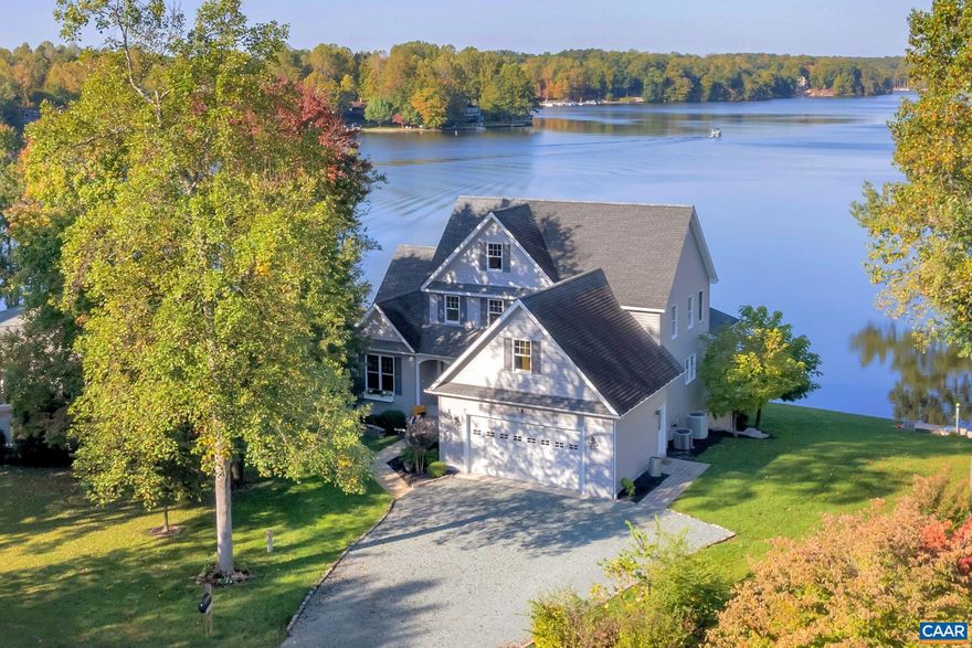 Stunning Custom Waterfront Home by Award Winning Taylor Lyn Homes. Situated on a private cove w/breathtaking Sunset & Main Lake Views. Elegantly appointed throughout w/extraordinary attention to detail. Enter into your open foyer to Main Lake Water Views. Great room w/soaring ceilings, floor to ceiling stone fireplace, hardwood flrs, formal DR, open kitchen w/granite & Quartz counter tops, double oven, gas cook top, ss appliances, center island, pantry, built in desk nook, breakfast room which adjoins Sun Room & Deck Area.  First level Primary Suite w/water views, sitting area, attached bath, dual vanities, tiled shower, soak tub & walk in closet. 1st level laundry, adjacent to attached 2 car garage. Open staircase to 2nd level features 2 additional bedrooms, full bath & a bonus room/bedroom, walk in attic. Escape to the lower level to a large family/Rec Room, 4th bedroom/home office, full bath & 2 separate storage/utility rooms.  Flat walk to the amazing 165'+ of prime waterfrontage. Boat Dock, 5 Zone irrigation system w/lake pump, private beach, grassy play area. Double tilt sash windows throughout, maintenance free siding, professional landscaping. The Sunsets are incredible as this home captures a view of the entire main lake.,Granite Counter,Quartz Counter,Wood Cabinets,Fireplace in Great Room