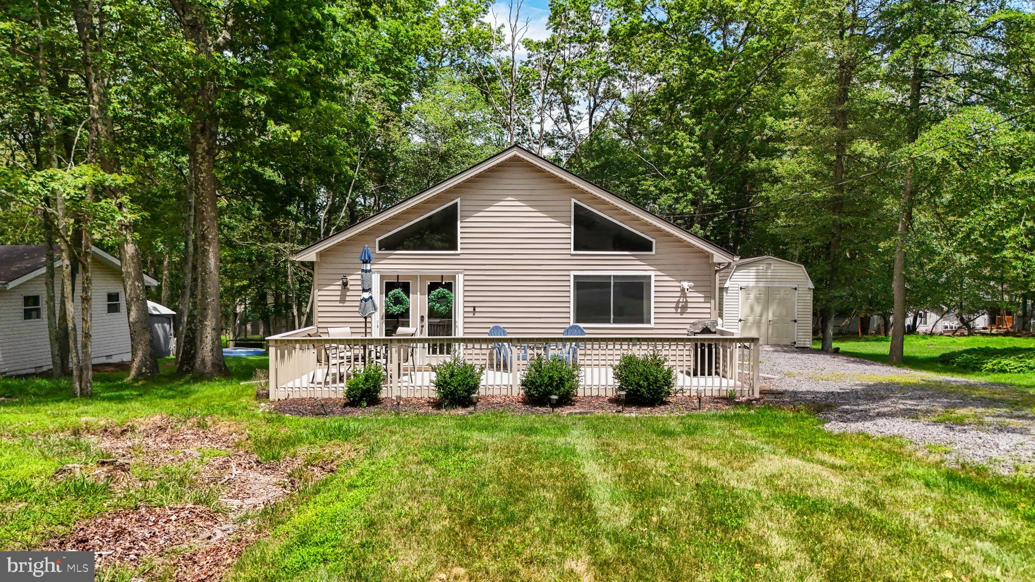 Welcome to 644 Old Stage Road, a beautiful 3-bedroom, 2-bath chalet-style home located in the amenity-filled Towamensing Trails community. This one-level living property is tastefully finished, including luxury plank flooring throughout and a fresh, neutral color palette. The open-concept living area features vaulted ceilings, an abundance of natural light, and a lovely stone gas fireplace. The fully equipped kitchen connects seamlessly to the dining area. A spacious front deck offers additional outdoor enjoyment perfect for relaxing outdoors or hosting guests. The layout includes the main bedroom with an en-suite bath, two additional generously sized bedrooms, and a second full bathroom with a shower/tub combination. The home sits on a sizable lot with a backyard ready for recreation or quiet enjoyment. As part of Towamensing Trails, members enjoy access to a range of amenities including a lake with beach access, rowboat and paddle boat rentals, a swimming pool, game room, clubhouse with bar and restaurant, volleyball area, and playground. Whether you're looking for full-time living, a mountain getaway, or a rental investment, this home offers the flexibility and features to fit your needs and lifestyle.