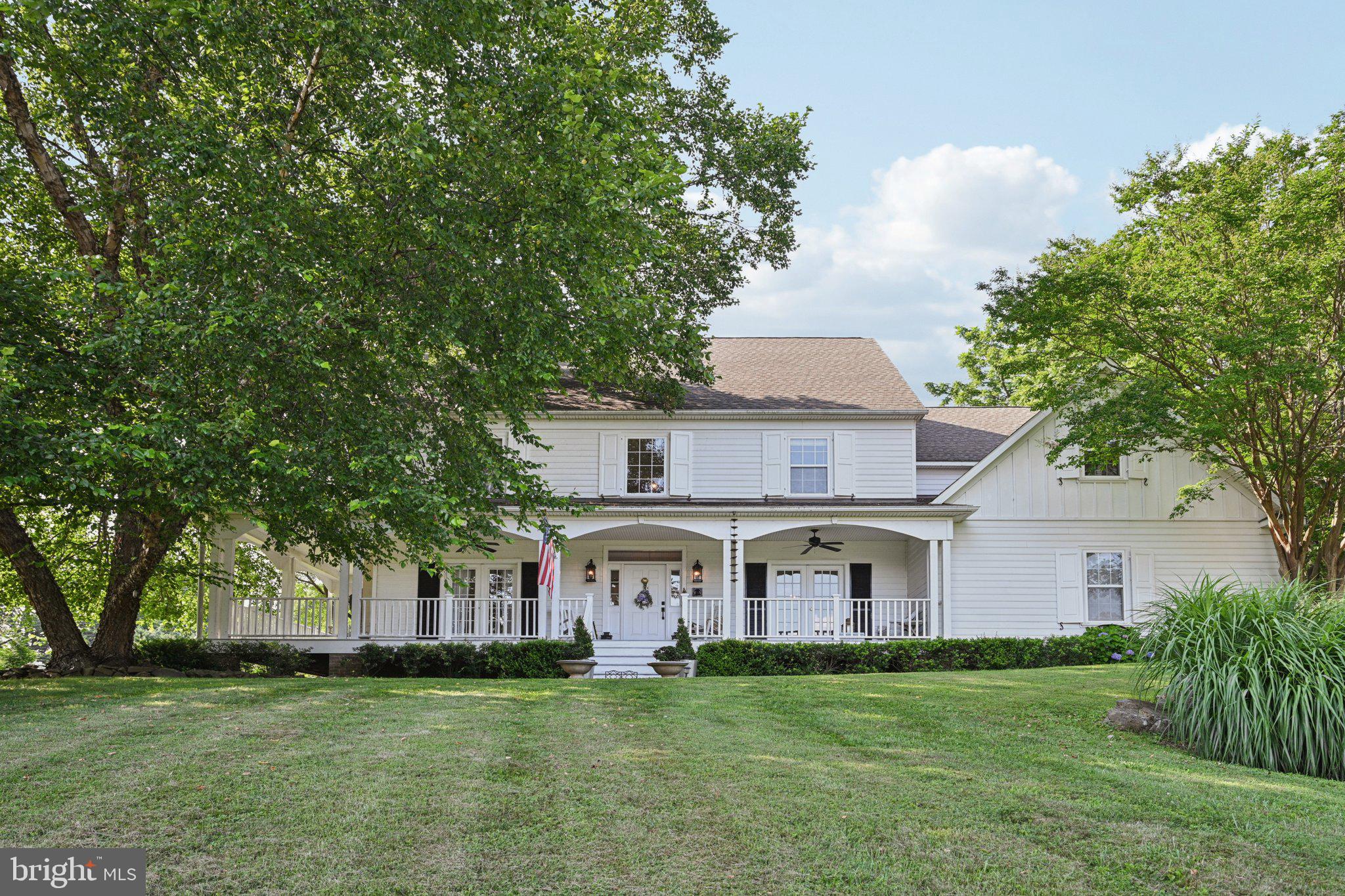 Welcome to 1051 Saint Matthews Road, a breathtaking custom residence set on 2.67 private acres in the heart of Chester Springs. A long, gently sloping front lawn leads to the stately southern-facing home, where a wide wraparound porch offers panoramic views. Step through the front door into a dramatic two-story foyer, where natural light pours in and sets the tone for the elegant yet comfortable interior.
To your left, the living room features a fireplace and French doors that open directly onto the front porch—ideal for seamless indoor-outdoor living. To your right, the formal dining room is enhanced with timeless wainscoting and another set of French doors to the porch, perfect for hosting guests in style. Throughout the main level, refinished hardwood floors and thoughtful design details create an open, airy feel. Sliding barn doors add both character and function, subtly separating spaces while allowing light to flow freely.
The newly renovated gourmet kitchen is a chef’s dream, featuring brand-new appliances, convection cooking, a central island with a pop-up vent, and a side door leading conveniently to the backyard patio. The open-concept layout makes entertaining easy, and newly installed Andersen double doors connect the kitchen and living space to the expansive slate patio—extended in 2024 to create the ultimate outdoor entertaining area.
Upstairs, a luxurious primary suite with tray ceiling, walk-in closets, and a stunning spa-like bathroom awaits. Setting the scene to unwind, the primary bath includes a deep soaking tub perfectly positioned beneath a new picture window overlooking the lush, tree-lined backyard. Three additional bedrooms are sizable and share two thoughtfully updated baths - One with a standing shower, the other with a tub. An additional bedroom or home office is located just off the primary suite, offering flexible living options. The fully finished walk-up lower level expands your living space even further, featuring a flex space perfect for work or guests alike, a generous half bath, an exercise room, and an all-purpose entertaining area complete with a custom bar.
Outdoors, the beautifully landscaped grounds are filled with blooming hydrangeas, peonies, red pear and peach trees, and a beautiful balance of open lawn and natural privacy. In winter, enjoy peaceful views through the trees down to a tranquil pond beyond the property line—a stunning reminder of the natural beauty that defines Chester Springs. This home has been meticulously maintained and updated and is ready for its next family. With dual-zone HVAC you will enjoy comfortable surroundings year-round! Local to the PA turnpike, Marsh Creek Park, and the shops and dining in Exton while still tucked away, this home offers the perfect combination of accessibility and privacy.
Thoughtfully designed, masterfully built, and terrifically maintained, this is truly a one-of-a-kind property you won’t want to miss!