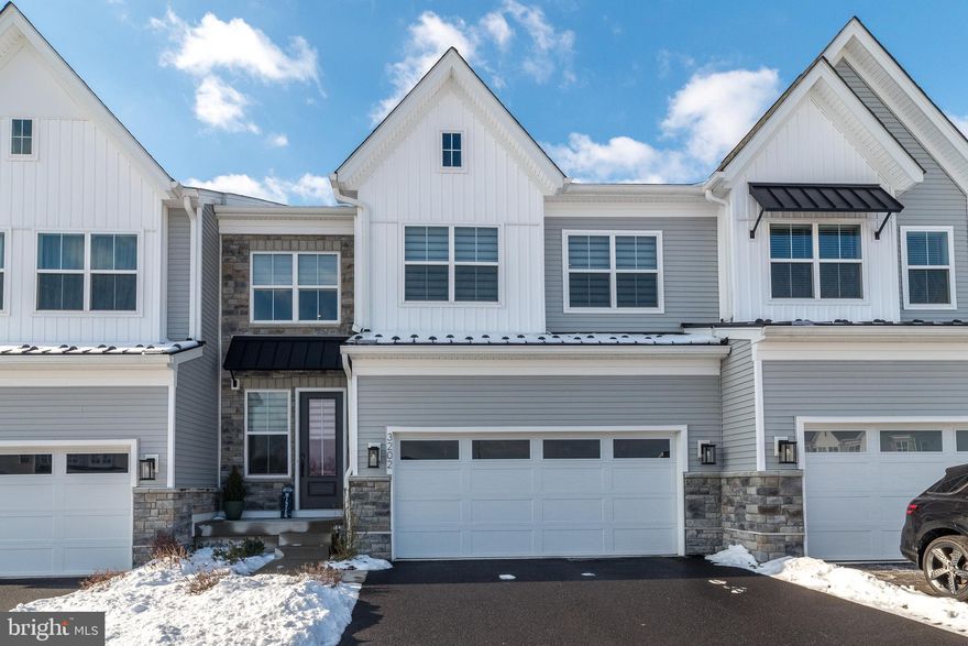 Welcome to this stunning, better-than-new Dalan Model carriage home, ideally situated in the exclusive Reserve at Emerson Farm, a prestigious Toll Brothers community in Warrington Township. Just one year young, this home offers premium upgrades, a thoughtfully designed open-concept layout, luxurious designer finishes, and a neutral palette throughout. A charming stone façade and inviting front porch set the stage for the elegance inside. Step through the front door into a breathtaking two-story foyer, where natural light floods the space, illuminating the gorgeous upgraded light oak hardwood floors that seamlessly flow throughout the main level. Designed for modern living and effortless entertaining, this home boasts a chef-inspired kitchen with TONS of upgrades, featuring abundant white cabinetry with crown molding and gold hardware, quartz countertops, a stylish tile backsplash, an oversized island with Arctic Island Blue cabinetry, a generous walk-in pantry for effortless organization, and higher end stainless steel KitchenAid appliances. The adjacent spacious dining area, enhanced by a new designer chandelier, accommodates even the largest gatherings with ease. The expansive great room showcases a wall of windows with desirable southern exposure, bathing the space in natural light. A mudroom entry from the two-car garage, a convenient powder room, and recessed lighting throughout complete the main level. Step outside through sliding glass doors to the maintenance-free deck, overlooking a newly added full-length paver patio—an ideal setting for summer entertaining and outdoor relaxation. Upstairs, a versatile loft with open rails overlooks the foyer, featuring a grand Palladian window with picturesque views beyond the neighborhood. This flexible space is perfect for a home office, reading nook, or cozy retreat. The luxurious owner’s suite offers a serene escape, complete with a spacious walk-in closet and a spa-inspired en suite bath, featuring a double vanity, seamless glass walk-in shower with built-in ledge, upgraded tile from floor to ceiling, and private water closet. Two additional well-sized bedrooms, each with walk-in closets and recessed lighting, share a beautifully appointed hall bath with a double-sink vanity and tub/shower combination with floor to ceiling tile. An oversized second-floor laundry room with durable vinyl plank flooring and laundry tub adds convenience. The full finished basement provides additional living and entertaining space, complete with an egress window for safety, rough-in plumbing for a future bath, and ample storage. Additional upgrades include WiFi-enabled thermostats, a three-zone HVAC system for energy efficiency, an upgraded WiFi enabled garage door opener, electric blinds  for effortless light control, modern one-panel Shaker interior doors with matte black hardware, and sleek eased-edge baseboards throughout for a contemporary finish.  This exceptional home blends sophistication, comfort, and functionality in one of Warrington Township’s most desirable communities. Don’t miss this rare opportunity—schedule your private showing today!