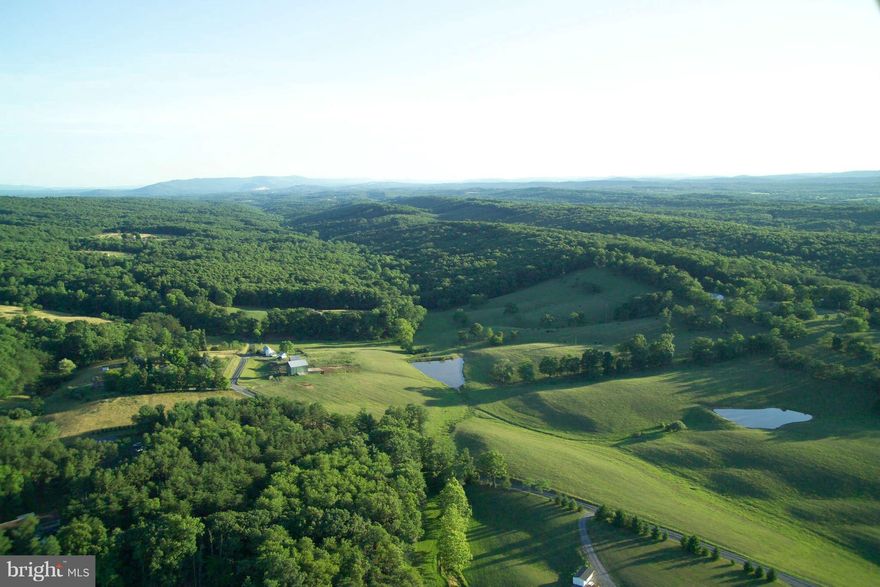 BIG PRICE DROP! 54.884 acres on a gentle slope with 2 ponds & great mountain backdrop.( 2 )2 acre building lots adj.NOW INCLUDED. Truly idyllic setting that folks dream of. Partially  fenced with 3 board wood fence, has corral, nice green barn and granary. 20 minutes to Winchester, 15 to spa/resort town of Berkeley Springs. Hard surface rds 1/2 mile +-  state maintained road frontage Unrestricted.