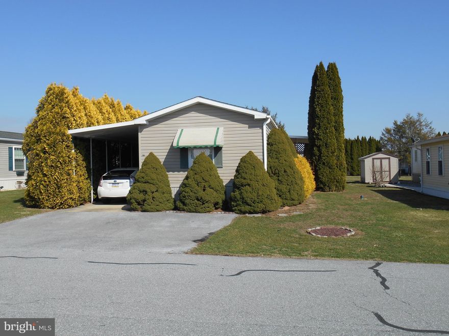 This manufactured home is a hidden gem, literally. Surrounded by mature arborvitaes you have total privacy in the Country Acres Gold Retirement Park located just west of Myerstown.  Attached carport and lean-to covers main entry as well as patio area.  Well maintained  property with added conveniences well planned by seller.  Back deck with garden spot for those with a green thumb. If your looking for ease of living and a quiet, peaceful neighborhood for 55+ close to all amenities: grocery stores, restaurants, salons, etc. this is it! 
Main bedroom with full bath on west end and another full bath for company and Bedroom #2 on  east end of home. New Roof and Water heater within past 2 years. Ready to go.