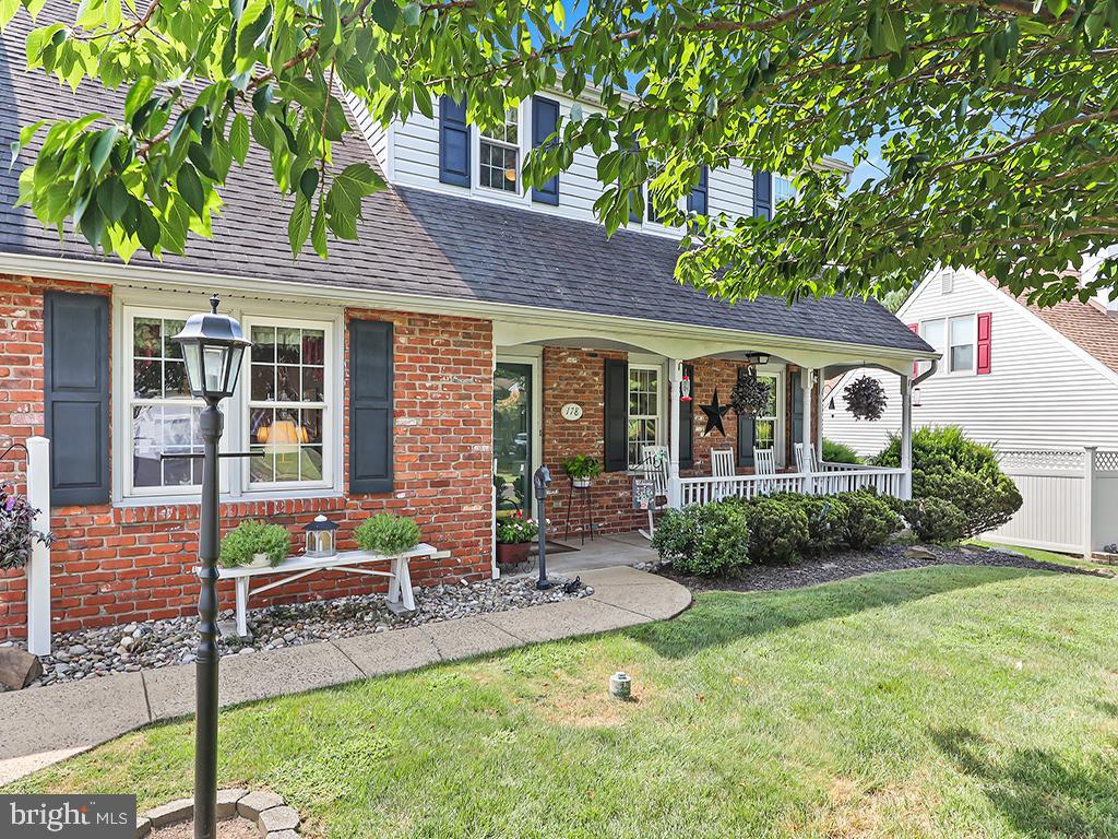 Nestled on a quiet circle drive and bordering over 25 acres of preserved green space, this home offers serene privacy with picturesque views in a neighborhood of winding cul-de-sac roads. A welcoming covered front porch sets the tone, offering the perfect spot to relax and enjoy the peaceful surroundings. Step inside, and your eye is immediately drawn through to the back of the home, where lush greenery and private views create a sense of retreat. The foyer, complete with a coat closet, opens to both a comfortable living room and a warm family room featuring a brick fireplace and built-in shelving—ideal for displaying cherished keepsakes or creating a stylish bar area. The main level flows easily from room to room, creating a natural circular layout perfect for both everyday living and entertaining. The dining room connects seamlessly to the kitchen, where light wood cabinetry, generous space for a dining table, and luxury wood-grained plank flooring create a bright and welcoming hub of the home. This upgraded flooring continues throughout the entryway, kitchen, bathrooms, and laundry area, bringing both style and durability. Just off the kitchen, a versatile area includes an updated half bath, laundry, a spacious closet, garage access, and a walkout to the back patio. The patio, complete with a pergola, provides the perfect backdrop for outdoor dining, grilling, or entertaining. Upstairs, you’ll find four spacious bedrooms and a nicely updated full bathroom. One of the bedrooms is oversized and currently serves as a flexible space—perfect as an office, additional sitting room, or bonus area. This room also offers great potential to be converted into a primary suite, should the new owners desire. The oversized garage is another highlight, offering not only parking but also a workshop area and ample storage space. Lovingly maintained and thoughtfully updated by the original owners, this home combines comfort, character, and privacy—ready to welcome its next chapter.