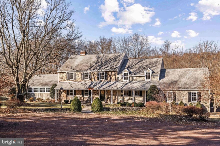 Nestled on a private 3.8+ acre property in coveted Upper Makefield Township, this beautifully maintained stone-fronted home offers a harmonious blend of traditional charm and modern convenience. Boasting 5 bedrooms and 4.1 baths, this comfortable home features a flexible floor plan, ideal for multigenerational living. It offers a first-floor bedroom suite, showcasing a handsome full bath with a stacked stone and river rock roll-in shower, vaulted ceiling, and French doors opening to an Ipe hardwood rear deck, pergola, and access to the inviting inground pool.  A home office with fireplace is nearby and can create an entire in-law or guest suite if needed. Hardwood floors flow throughout the main rooms of the expansive interior, which has been freshly painted with a soft color palette. The entrance foyer with turned staircase has charming easy-care slate floors and is the segue to all living spaces.  A spacious living/dining room with fireplace is now solely being enjoyed as a gorgeous dining room, with built-in cabinetry and shelving, wainscotting and lighted cove molding. The core of the home is centered around a grand two story-great room with stone fireplace and wall of windows, with access to the outside deck and pool, and open to the gourmet kitchen.  The great room can handle large gatherings and enjoys a handy serving bar direct from the kitchen for easy entertaining.  The well-designed kitchen with wood cabinetry has granite countertops, a center island with bar sink, and stainless appliances, including a 5-burner Wolf induction range, additional wall oven, built-in microwave oven, Thermador dishwasher, and Subzero refrigerator/freezer with icemaker.  A bright and sunny breakfast area allows for casual meals.  Upstairs, there are 4 spacious bedrooms, (two en-suite and two sharing a hallway bath) allowing for completely separate living spaces and a second main bedroom suite. Thoughtfully designed with practicality in mind, the home offers front and rear staircases, two laundry areas (one on each floor) a whole house back-up generator, whole house fan, newer clad windows, newer dimensional shingle roof, zoned heat and high velocity air conditioning, a walk-up attic,  and walk-out basement at grade level.   Outdoors, while relaxing on the rear deck or by the pool, enjoy a meticulously maintained and private yard with partial deer fencing, scenic views of Jericho Mountain, and a serene setting.  There is even an ornamental gold fish pond! Recently updated with a new front door, interior and exterior paint, modernized lighting fixtures, and more, this pristine home is located in the highly regarded Council Rock School District, with convenient access to I-95, Princeton, shopping and major airports.  This happy home can be yours to enjoy in all seasons!