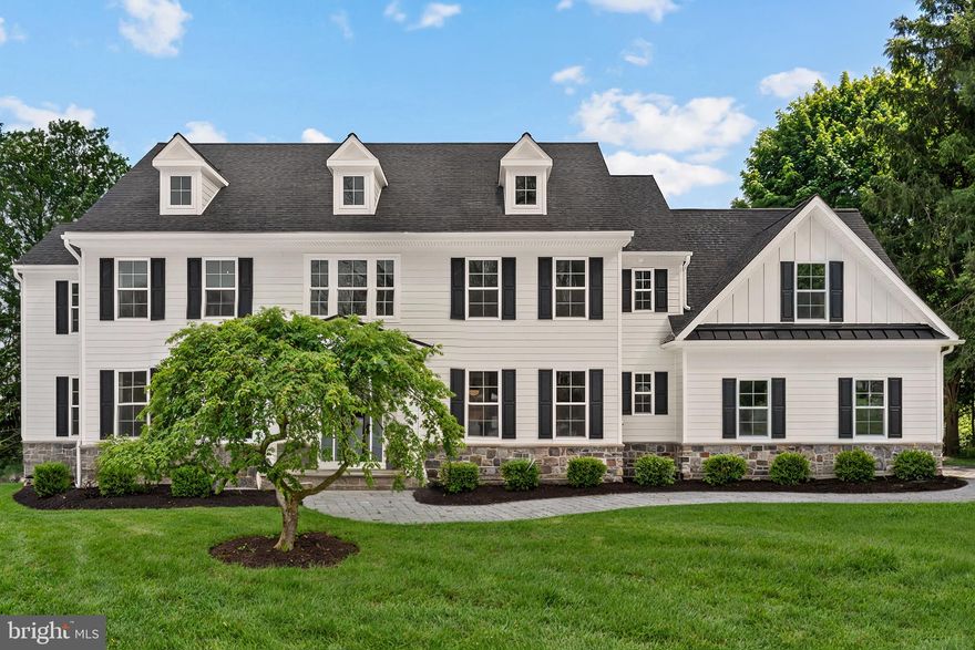 Welcome to 17 Hickory Lane — a stunning traditional new construction home by local custom builder R. Custom Homes, perfectly positioned on a flat one-acre lot in sought-after Willistown Township within the Great Valley School District. A covered front entry with flagstone landing leads to a beautifully illuminated front door and welcoming foyer adorned with custom millwork and site finished select natural white oak hardwood floors that flow seamlessly throughout the main level. The hall closet and powder room with custom built-in decorative shelving nook just off the foyer ensure effortless everyday flow and design aesthetic. The formal living and dining rooms flank the entry, offering elegant yet functional spaces ideal for both everyday living and entertaining. At the heart of the home, the thoughtfully designed kitchen impresses with high-end, all plywood shaker cabinetry, under cabinet lighting, pot filler, extensive storage, and a chef’s suite of Thermador appliances including double ovens, a 5-burner gas range, built-in microwave, and a smart refrigerator with interior cameras. The contrasting island with breakfast bar anchors the space, while a designated coffee bar and adjacent breakfast area with built-in illuminated display cabinetry and space for a beverage refrigerator add charm and practicality. Sliding glass doors open to the rear yard - specs for a deck or patio are available. The level backyard provides endless possibilities allowing space for a possible future pool. Just beyond the breakfast area, the great room is framed by a cased opening, custom built-ins and features a coffered ceiling, abundant natural light, and a gas fireplace surrounded by custom millwork. The quiet home office with closet tucked just around the corner offers a perfect set up. The main level is completed by a beautifully designed mudroom with built-in cubbies, walk-in coat closet and a striking herringbone brick floor, a private laundry room with custom wood countertop, upper and lower cabinetry, and laundry sink. Upstairs, the primary suite offers a vaulted and beamed ceiling, designer carpeting, and a generous walk-in closet - specs available for closet organizers. The spa-inspired en suite bath features heated marble floors, a soaking tub, frameless glass shower, dual vanities, and a private water closet with pocket door. Bedrooms two and three share a Jack-and-Jill bath with double vanity. Bedroom four functions beautifully as a junior suite with direct access to a full bath, while bedroom five enjoys convenient hall access to that same bathroom - this substantial room is also ideal for flex space to meet your specific needs — offering flexible options for guests, family, or bonus space. The unfinished walk-up lower level is plumbed for a full bath and presents limitless potential for future finished living space of up to an additional 1800 square feet. This is a rare opportunity to enjoy brand-new construction without the wait — thoughtfully designed, beautifully executed, and ready to welcome its first owner.