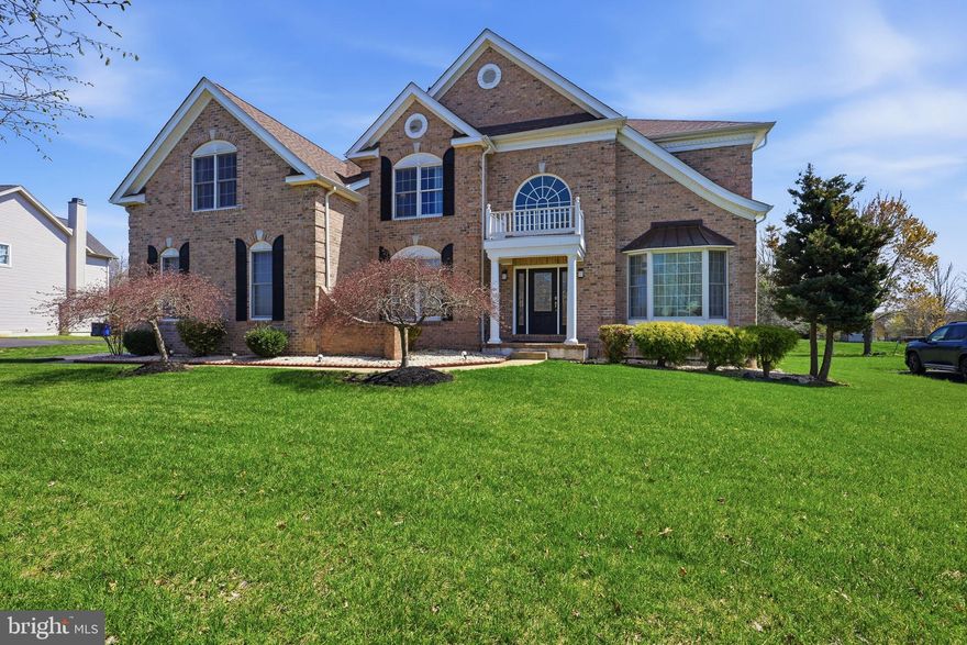 Exceptional curb appeal defines this impressive five-bedroom, four-and-a-half-bath brick and vinyl residence with a three-car turned garage, nestled in the highly desirable, amenity-rich community of Red Lion Chase. Residents enjoy a clubhouse, fitness center, swimming pool, tennis and pickleball courts, basketball courts, and playground.  Step inside the grand two-story foyer, where gleaming hardwood floors extend through the living room, dining room, and kitchen. The foyer is flanked by a private first-floor office and a formal living room that flows seamlessly into the dining room, featuring elegant chair rail molding—perfect for hosting memorable gatherings.  The gourmet kitchen is a chef’s delight, offering a pantry, oversized center island, granite countertops, undermount double-bowl sink, 42” cabinetry, tile backsplash, recessed lighting, and a sun-filled breakfast nook with French doors that open to a cobblestone stamped patio. The beautifully landscaped backyard includes an irrigation system and raised kitchen garden, creating an ideal setting for outdoor entertaining. The kitchen opens to a light-filled family room with soaring vaulted ceilings, recessed lighting, and a stunning brick fireplace.  A graceful turned staircase from the foyer—along with a convenient secondary staircase from the family room—leads to the upper level. The luxurious owner’s suite features a private sitting room, two expansive walk-in closets, and a spa-inspired en-suite bath with soaking tub, double vanity, ceramic tile flooring, separate shower, and private water closet. The second floor also includes Jack-and-Jill bedrooms with a shared bath, plus a fourth bedroom with its own private bathroom.  The finished lower level offers remarkable versatility, featuring a spacious recreation area with a home entertainment space, a room currently used as a bedroom, a full bathroom, and wide walkout egress to a paver patio.  Additional highlights include a new premium roof (2025). Offering exceptional space, comfort, and resort-style community amenities, this outstanding home is a must-see—schedule your private showing today.