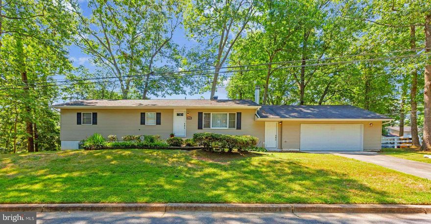 Spectacular Spacious Home on Quiet Wooded Lot in Sought After Glenn Dale. Updated Kitchen with Granite Countertops, Wood Cabinets, Newer Stove, Fridge and Dishwasher (2019 for all 3).  Gorgeous Hardwood Floors Throughout the Main Level. Many Spacious Bedrooms, All Baths Updated. Fully Finished Lower Level with Bedrooms, Full Bath and Walk-Out to Patio and Wooded Backyard. Wood Burning Fireplace in Living Room to Enjoy on those Cold Winter Evenings.  Three New Pella Doors installed in 2022.  Oversized 2 Car Garage with Plenty of Storage Space.  Enclosed Breezeway between Home and Garage.  Beautifully Maintained, Will Go Quickly. Very Easy to Show, Call Helpful Listing Agent With Any Questions.  AS-IS SALE