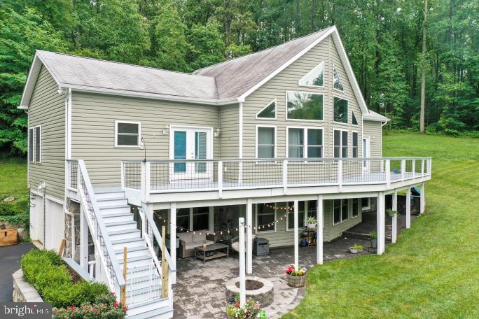 Short term rental possibilities! Priced under tax assessment. Charming, custom-built A-frame chalet, meticulously maintained and constructed in 2017, is nestled on over 7 private acres at the base of the mountain in scenic Linden, VA is waiting for you. The property boasts impressive stone retaining walls, multiple inviting patios, and a cozy fire pit, creating an ideal outdoor oasis. The upper level features a primary suite with its own private entrance to deck and an ensuite bathroom. The finished basement offers additional living space, including a bonus bedroom and bathroom with clawfoot tub. A convenient two-car garage provides ample parking and storage. Perfectly situated for easy access, it's located directly off a state-maintained road, ensuring year-round convenience. Additionally, an oversized 20 x 12 workshop or storage building provides ample space for hobbies, equipment, or future expansion. Front facing windows have UV film tint to keep the home cooler in summer. Wine enthusiasts will delight in its proximity to acclaimed wineries like Rappahannock Cellars, Capstone Vineyards, Linden Vineyards, and Fox Meadow Winery. Fresh produce a mile away at The Giving Tree.