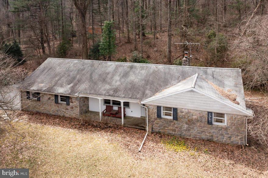 This 3 Bedroom and 1 Bath Stone Rancher was built by Paul Moyer in 1964, it sits on 25+ acres of wooded and pasture property in the Boyertown school district.  The previous owner had horses and there is a horse stable and several outbuildings on the property.  This home has a large living room with hardwood flooring and the kitchen is attached to the dining room that features a stone fireplace with wood insert.  The bedrooms all have large closets and hardwood flooring.  There is also a large laundry room on the main floor.  The basement is unfinished but could easily be finished and there is a workshop area as well.  There is 200-amp electric service, electric baseboard heating as well as a wood stove that heats the entire upstairs.  The large 2 car garage has plenty of room for storage as well as a walkup attic for storage.   There is a front porch with a beautiful view and rear patio to relax and entertain guests.  The home has incredible potential but needs updating throughout the home as well as exterior.  Home is not in Act 319, clean and green.  Located in Earl township, the trash is paid for by the township.  Great opportunity for someone who wants to own 25+ acres, great hunting land, horses or animals could all be managed on this property.