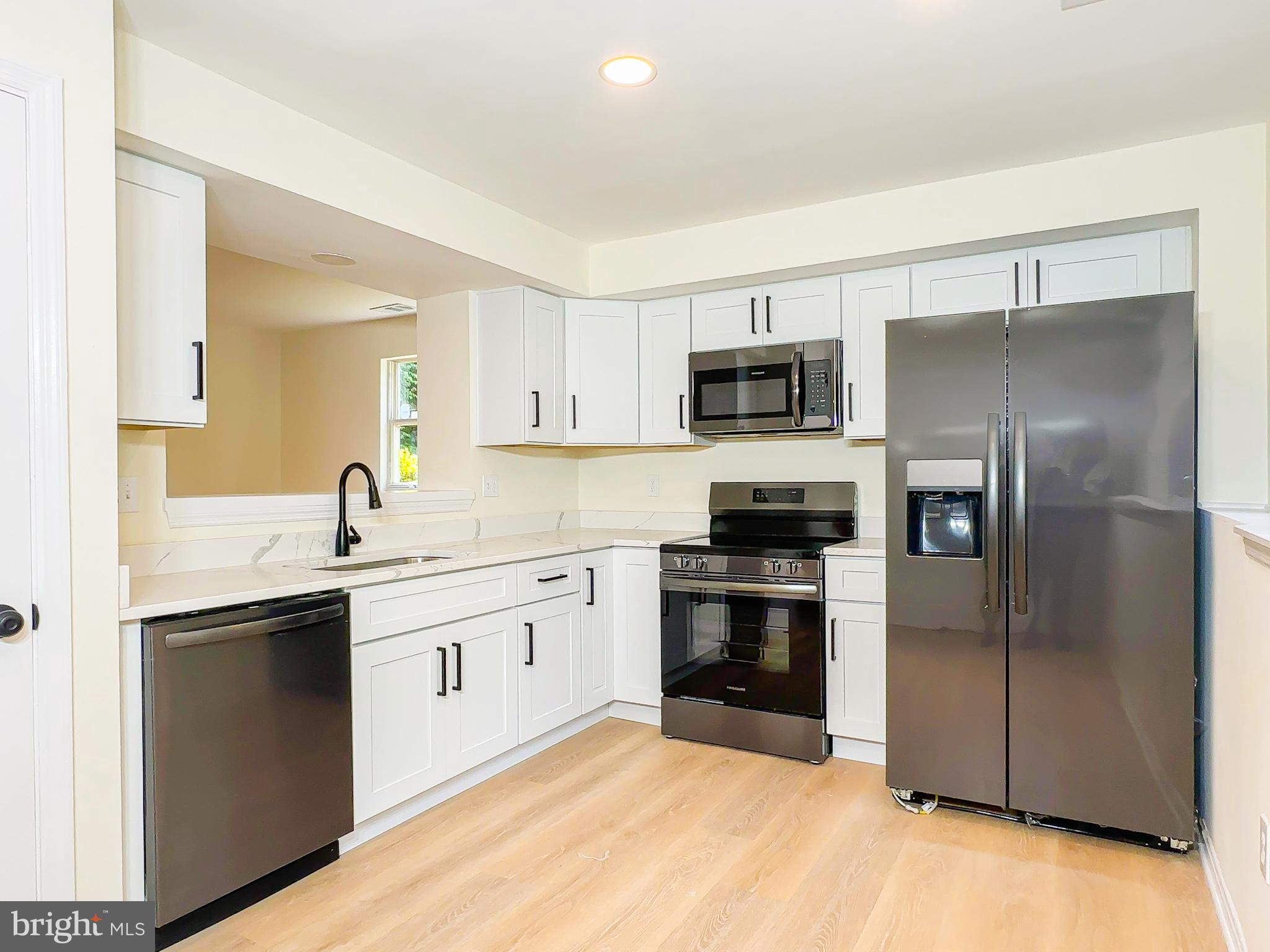 Discover unbeatable value and charm in this freshly updated 2-bedroom condo—perfect for first-time buyers ready to own instead of rent! Located in a quiet, tree-lined community just minutes from Largo Town Center, Metro, the Beltway, and D.C., this move-in-ready home offers comfort, convenience, and style. Step inside to find gleaming hardwood floors, a bright and spacious open-concept living area, and a private patio perfect for morning coffee or evening relaxation. The kitchen features modern appliances, ample cabinet space, and a breakfast bar that’s ideal for entertaining or everyday meals. You'll also love the in-unit washer and dryer, reserved parking, and low-maintenance living in a well-maintained community. Whether you're buying your first home or looking for an affordable investment, this hidden gem delivers on location, price, and peace of mind.