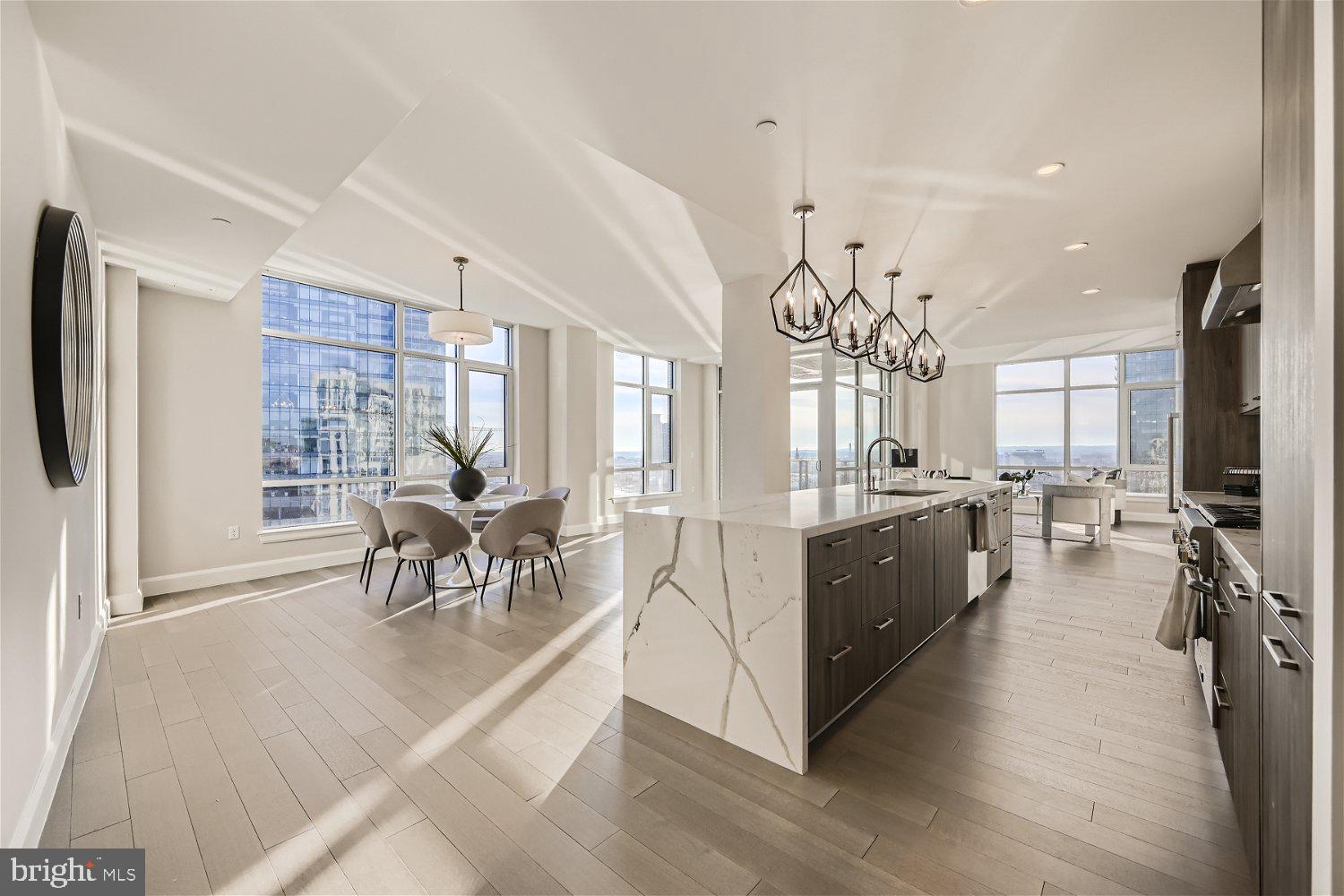 This spectacular corner three bedroom two and one half bath residence with over 2,900 square feet occupies a full-floor of this newly built condominium in Harbor East. Enter the residence through a private elevator vestibule with its own valet closet for discrete delivery. The sun flooded great room provides captivating river views and Baltimore’s Harbor through the floor-to-ceiling windows. The state-of-the-art open kitchen is a chefs dream, masterfully designed and meticulously appointed with Italkraft custom cabinetry and premium appliances by Thermador including a gas range with vented wall hood, and MicroDrawer microwave. The stunning oversized marble waterfall island flows seamlessly into the entertaining space. The primary bedroom suite was thoughtfully designed with a walk-in closet and illuminated spa bathroom outfitted with Kallista & Kohler fixtures, Carrara marble floors and walls, expansive walk-in shower and custom designed marble dual vanity. Two additional bedrooms and full bath. 2 garage parking spaces convey. New construction 5 year tax phase-in applies. Liberty Harbor East is Baltimores newest luxury waterfront address. The boutique condominium offering 33 residences with stunning waterfront architecture, designer finishes, and an enviable Harbor East location atop a brand new flagship Whole Foods Market create the opportunity for the ultimate downtown lifestyle. Liberty is located in the heart of Harbor East surrounded by best-in-class dining, shopping and conveniences of downtown living. Residents will enjoy a private Concierge level with social lounge, automated and secured package room and ButterflyMX intercom security system. Residents will also enjoy access to over 30,000 square feet of private, state-of-the-art indoor and outdoor amenity spaces including a clubroom with indoor/outdoor bar, rooftop infinity pool deck with cabanas, courtyard seating, grilling stations, communal and private dining rooms with catering kitchen, fitness center, yoga studio, Pet park with dog agility and training equipment, conference rooms, study lounge with computer stations and fireplace.