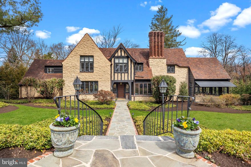 Welcome to 1319 Panther Rd located in Rydal, PA. Situated in an extremely desirable pocket of Montgomery County, this stunning home was originally built by the renowned Herkness Builder. Offering a blend of timeless elegance and modern upgrades, this residence is designed for both comfort and style.

The exterior boasts a whole-house generator, sprinkler system, and an irrigation system for the vegetable garden. A newly installed flagstone front walkway enhances the home’s curb appeal, while the built-in outdoor kitchen and expansive driveway, accommodating up to six cars, add to its functionality. Additional outdoor features include a newly built shed and a custom chicken coop (chickens not included).

Inside, the first-floor kitchen is a chef’s dream, featuring custom Amish-built cabinetry, Carrara marble countertops, and a butler’s pantry. High-end appliances include a Viking stove with a matching custom range hood, a Sub-Zero refrigerator with a custom cabinetry panel, and a Miele dishwasher also integrated into the cabinetry. Adjacent to the living room, the sun-drenched solarium provides a serene retreat with ample natural light. The living room itself showcases coffered ceilings, expansive windows, a beautiful fireplace with a stunning mantle, and a wood-burning fireplace with a gas line available for easy conversion. The home features three fireplaces—one on each floor.

Additional highlights include a newly updated 200-amp electrical service (5 years old), a whole-home security system, and a Sonos whole-house and outdoor stereo system. A hot water loop ensures instant hot water throughout. The garage and basement have been recently renovated, and the laundry room has been updated. The home also features relined ductwork, plaster walls and ceilings, and a clay roof that is inspected and certified annually for maintenance. Flooring consists primarily of hardwood throughout, with tile in the bathrooms and kitchen and carpet in the front and back stairs, upstairs hallway, and basement. The home is equipped with gas heat and hot water.  

The second floor features four spacious bedrooms, including a primary suite with an en-suite bathroom. Three additional large bedrooms share two full bathrooms and each bedroom has custom closets.  On the first floor, a full bath pairs with a guest bedroom, currently used as an office, while a half bath is conveniently located in the main foyer.

A breathtaking oak staircase with a modern carpet runner and Tudor-style wooden railing adds to the home’s charm. The finished basement includes a fireplace, cedar storage room, wine cellar storage, utility room, powder room, and two exits—one through the utility room and one through the two-car garage.

This meticulously maintained home offers a perfect blend of historic craftsmanship and modern amenities in one of Rydal’s most sought-after locations.