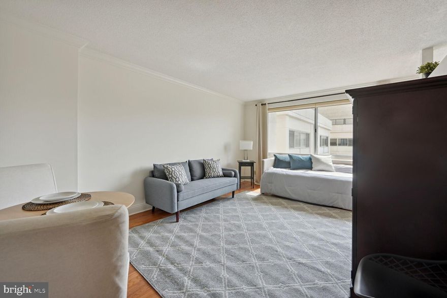 Lovely Jr 1 bed with 1 bath in The Willoughby! This charming unit features parking (#559P), ample storage, large windows facing southwest, hardwood floors, crown molding, floor molding, a newer convector and more! Enjoy the sun-soaked living room, perfect for entertaining or lounging, with enough space for a dining set. The kitchen offers a full-size stove with gas cooking and a refrigerator. There is a partial wall that closes off the sleeping area as well. The bathroom offers a new bathroom vanity, mirror and light fixture. You can also take advantage of the many amenities in the building, such as the rooftop pool, sundeck, reading room/library, and gym, or visit the Village Center across the street. The Friendship Heights Metro Station, Lia's Restaurant, Capital Grill, Clyde's, Junction Bistro, Saks 5th Ave., Bloomingdales, Tiffany's, and Whole
Foods are all in close proximity, offering endless dining and shopping options.