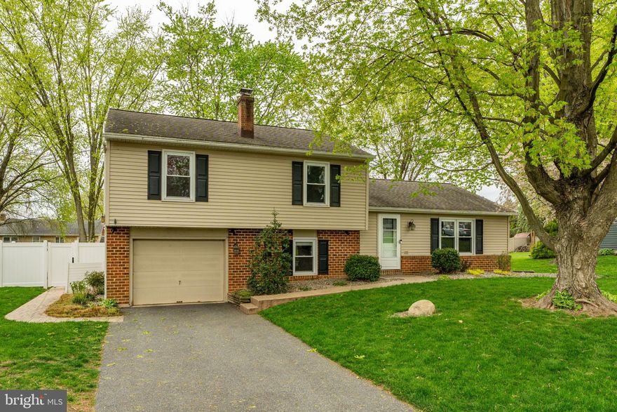 Welcome home to 468 Longmeadow Road! Featuring four generously sized bedrooms and two full and one half baths, the property blends classic curb appeal with modern convenience. The comfort and beauty of this home are enhanced through its open-concept kitchen and living room, which features vaulted ceilings, exposed beams, custom, built-in shelving, and a cozy fireplace. The spacious first-floor primary suite, which also has a private entrance from the fenced side yard, includes a wet bar and a luxurious en suite bathroom with a tiled shower and dual vanities. Heading upstairs, you will discover three more bedrooms and a second full bath, while the finished lower level provides additional living space with a family room and powder room. The inviting backyard is enclosed by a newer privacy fence and offers a garden shed, stamped concrete patio, and inlaid firepit-ideal for entertaining or relaxing beneath mature shade trees. This charming home is located off the beaten path yet offers quick access to Routes 501 & 722, just minutes from shopping, Lititz, and Lancaster. Schedule your showing today and see it for yourself!