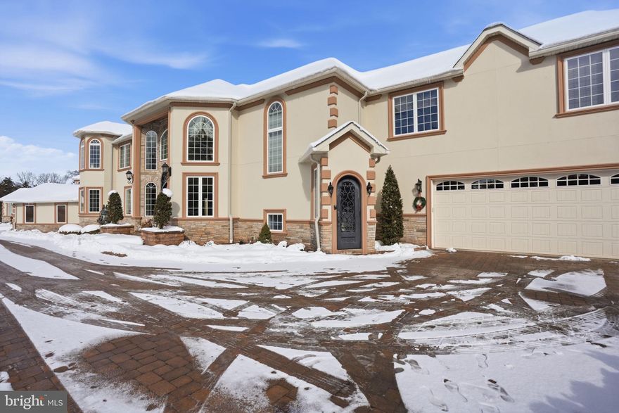 1066 Washington Crossing Road, Newtown, PA is one of the most extraordinary private estates ever offered in Bucks County. This fully gated and entirely fenced custom residence spans nearly 10,000 square feet of refined living space, offering approximately 8,000 square feet above grade plus an additional 2,000 square feet of finished lower-level living. Designed without compromise and built with no expense spared, the home delivers a rare combination of privacy, architectural significance, and lifestyle versatility within Upper Makefield Township.

The residence features six bedrooms plus a dedicated office, six full bathrooms and three half bathrooms, and an exceptionally rare open-concept floor plan that seamlessly connects grand-scale entertaining with everyday living. From the moment you enter, the home impresses with soaring ceilings, hand-crafted millwork, ornate plaster detailing, marble floors, and dramatic chandeliers—timeless details that reflect true custom craftsmanship throughout. The showpiece kitchen anchors the home and flows effortlessly into expansive dining and living spaces designed to host at the highest level.

A standout feature of the property is the expansive in-law suite, which functions as a home unto itself and offers two bedrooms, two and a half bathrooms, a full kitchen, and a private laundry room—ideal for multi-generational living, extended stays, or guest accommodations. In total, the home includes three separate laundry rooms for maximum convenience. Additional lifestyle amenities include a climate-controlled wine cellar, a half indoor basketball court, a beautifully designed outdoor pergola, custom garage space, and thoughtfully finished lower-level living areas that further enhance the estate’s functionality.

Built for comfort, security, and peace of mind, the home is equipped with a full-house generator supported by a 1,500-gallon underground propane tank, allowing the property to operate off-grid for extended periods if necessary. A state-of-the-art smart-home security system integrates cameras, gated entry controls, lighting automation, and advanced monitoring throughout the estate. Whole-home surround sound music systems extend through virtually every room, creating a fully immersive and connected living experience.

Additional highlights include five walk-in closets, a dedicated home office, and a layout that perfectly balances grandeur with warmth and livability. Located in the highly sought-after Council Rock School District and just minutes from the charm of Newtown, this is more than a residence—it is a legacy estate offering privacy, scale, and craftsmanship that simply cannot be replicated.