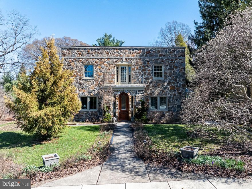 FOR THE LOVE OF STONE HOMES!! One of the hidden gems of Towson...welcome to Historic Towson Estates! An elegant stone residence boasting charm and character. With 3 bedrooms, 2 full bathrooms, 2 half bathrooms, and 3,381 finished square feet. This enchanting home showcases storybook curb appeal, with lush garden-lined pathways, a Juliet entryway, and timeless architectural details that hint at its rich heritage. Step inside to find hardwood floors flowing through the traditional main level. The foyer opens through French doors to a spacious living room, freshly painted, and featuring a stone-accented wood-burning fireplace—a perfect blend of warmth and sophistication. Opposite the foyer, the formal dining room impresses with an elegant chandelier that complements the home’s historic charm. The large eat-in kitchen boasts granite countertops, a decorative backsplash, and rich cherry cabinetry for plenty of storage. The kitchen leads into the sunroom, a captivating retreat enclosed in panoramic glass windows, creating a light-filled sanctuary that brings the outdoors in. Upstairs, hardwood floors continue throughout three bedrooms, including an expansive primary suite with double closets and a private sitting area.  The freshly painted primary bedroom also has an en-suite bathroom. A second full bathroom serves the additional bedrooms with equal charm. One of the bedrooms has a private balcony to enjoy your morning coffee, or just sit in solitude overlooking the gardens.  The third bedroom is large, freshly painted, and also has double closets. The lower level is a treasure of its own, featuring a recreation room with stone walls, a second stone fireplace, and exposed beams that showcase the home’s craftsmanship. Two bonus areas with built-ins, a half bathroom, laundry room, and a former darkroom provide character-rich versatility. Outdoor living is a gardener's dream, with meandering stone walkways, vibrant gardens, and a stone fish pond, all set against a wooded backdrop for added privacy. A two-car garage and private driveway provide convenience and ample parking. Nestled within Towson Estates, a neighborhood celebrated for its old-world charm and early 20th-century architecture, this residence is part of a community where stone walls, gardens, and fountains create a picturesque, timeless atmosphere. The neighborhood association is dedicated to preserving the historic integrity and ensuring each home retains its distinctive character. Tucked away on quiet, no-through streets, yet just minutes from shopping, dining, major commuter routes, and amenities, this home offers the perfect harmony of history, privacy, and convenience.  Walk the neighborhood and enjoy the community gardens and stone fountains throughout! Fireplaces are decorative only,  seller is not sure if they are usable. She never did. Furnace/Boiler and Water Heater recently replaced (gas; chimney liner installed).