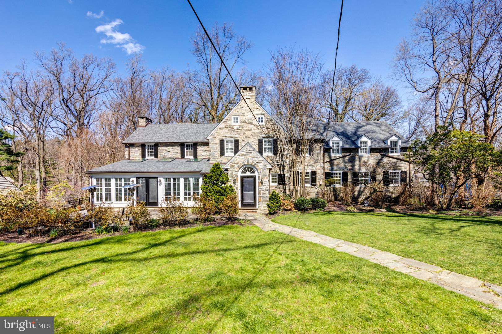 Gracious Walter Durham fieldstone colonial nestled on one of North Haverford’s most sought after streets. Beautiful archways, elegant millwork, oversized fireplaces, beautiful hardwood floors and large windows with deep sills make this home a classic treasure. The Old World charm is complemented by the much desired spaces, including a kitchen that opens to a family room drenched with glorious light with a wall of windows overlooking the deck. A bright sunroom walks out to a flagstone terrace. The formal spaces graciously exude the era of this home. A classic dining room with wainscoting is perfect for entertaining. The living room features beautiful built ins and an oversized fireplace. Even the front door graces you with herringbone brick floors and a stunning archway. Well placed skylights and french doors bring beautiful light throughout the house. Upstairs, a master suite has a large walk in closet and a master bath ready for your updates. Three additional bedrooms are well sized and share two additional full baths. Second floor laundry suite offers every convenience and is accessed easily from a back staircase off the kitchen. A wide staircase to the third floor leads to a small 5th bedroom. In the basement, a finished play room is accented by an oversized stone fireplace. Two car garage. New roof in 2021. Mudroom entrance off the basement garage access. Around the corner from the Merion Cricket Club, a quick drive to Haverford Town center, train station, Haverford College nature trail. A commuters dream close to all major roadways and train. Awar winning Lower Merion School District.