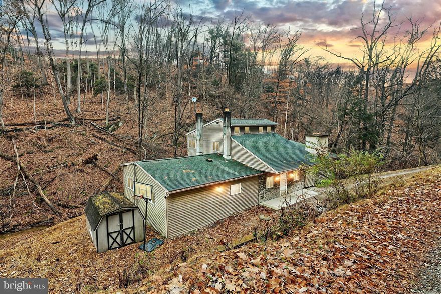 Get away from it all where the blacktop ends and the river begins. This rare 3 bed, 2 bath cabin on owned land is tucked away on a remote, nearly one acre lot with Green Branch Creek cutting through its rolling, wooded landscape on its way to the banks of the Susquehanna River just beyond the trees. Whether it is hiking, fishing, boating, watching abundant wildlife or simply enjoying the delights of nature, adventure awaits you here, just a stone's throw from numerous natural heritage areas, parks and waterfront access. The secluded home offers the convenience of one-level living, including first floor primary suite and laundry, plus two additional bedrooms upstairs for family or guests. The open kitchen and dining room area is equipped with a full array of appliances, cozy wood stove and slider to the wrap-around deck. Just off the dining area, the spacious living room with exposed log beams and walls showcases a handsome stone fireplace, large windows and a second slider to the deck, for maximal enjoyment of the peaceful setting. The huge primary suite includes an open bath area with walk-in shower and jacuzzi tub, which can easily be enclosed. The partial basement with walk-out access provides ample storage or room to add a workshop, and a newer roof, installed in 2019 adds peace of mind. Some updating and TLC will bring this unique property to its full potential as a perfect escape from the hustle and bustle of modern life. Sold as-is. Cash or strong conventional financing only.