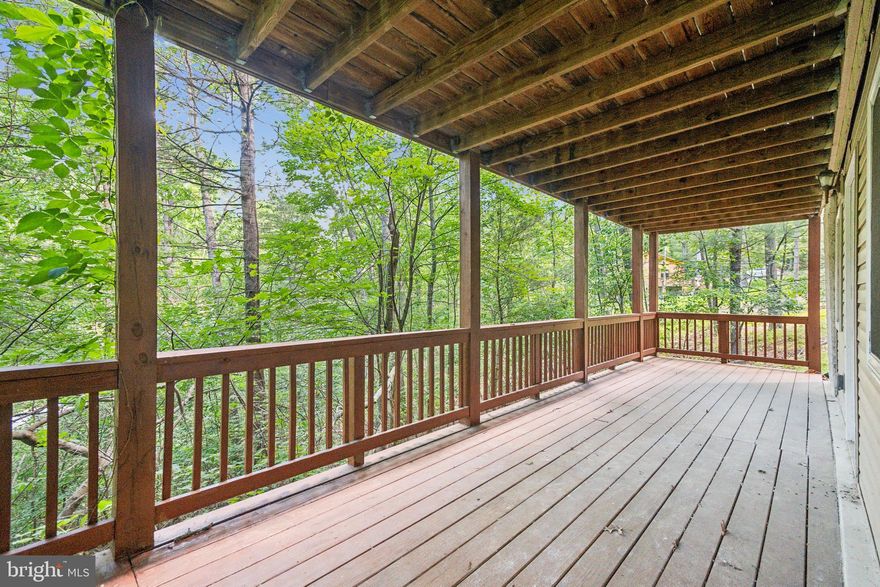 Escape to this inviting A-frame cabin tucked among the trees in Mount Jackson, VA. This 3-bed, 2-bath retreat offers bright, open living with vaulted ceilings, large windows, and a wood-burning stove that makes the space feel instantly cozy. The finished lower level adds a flexible family room, full bath, and laundry.
Relax on the wrap-around deck or covered porch, where you can enjoy the woods around you while still being close enough to a main road for easy access and everyday convenience. Set on a 1-acre lot and including Lots 077A-01-005B & 077A-01-005C, the property features a private well, private septic, and a quiet natural setting without feeling too remote.
Just 3 miles from Bryce Resort and minutes from local wineries and small-town charm, this cabin is perfect for weekend escapes, full-time living, or a rental-friendly mountain getaway.