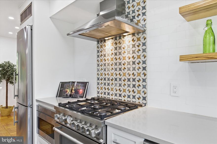 Don't miss this beautifully remodeled 2BR/1BA in Parkfairfax — truly turnkey and move-in ready. Every detail has been thoughtfully considered, from the energy-efficient mini splits and double-paned windows to the fully updated kitchen and bathroom. Recessed lighting flows throughout the first floor, and the home's appeal begins the moment you arrive, with a well-kept front yard that sets the tone for the quality you'll find in every room.

The galley kitchen has been expanded to accommodate three floor-to-ceiling pantry cabinets, all part of a complete renovation featuring custom Omega Cabinetry. It's outfitted with everything a home cook could want: a Liebherr refrigerator, Bertazzoni range, Bosch dishwasher, and Sharp under-counter microwave. Floating shelves on each side of the kitchen keep the space open while putting everyday essentials within easy reach — ideal when serving guests in the adjoining dining room. A fourth corner pantry cabinet just outside the kitchen offers convenient storage for less-used items and table linens. Come see how effortlessly this kitchen could become yours.

As a Parkfairfax resident, you'll also enjoy three outdoor pools, a fitness center, a party room, tot lots, and on-site recycling and trash services — making this one of the most amenity-rich and environmentally conscious communities inside the Beltway!