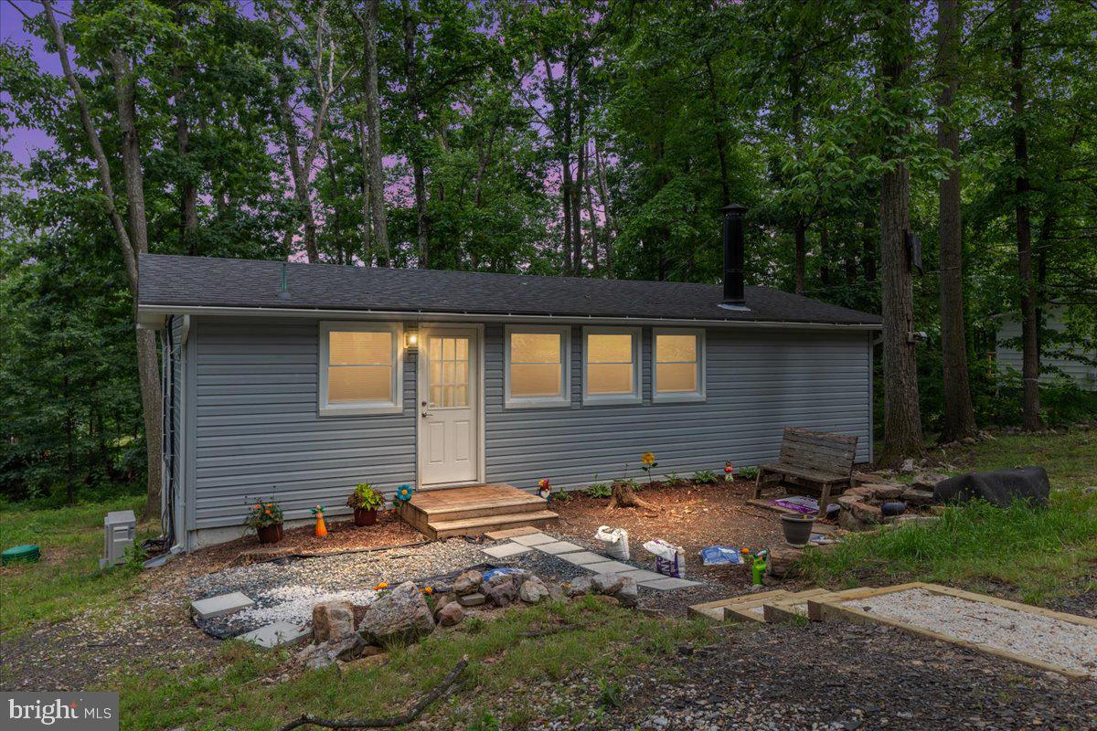 This move-in ready home in the sought-after Shawneeland community offers the perfect blend of modern comfort and natural beauty. Featuring a newer roof, newer washer and dryer, updated lighting and fixtures, and a beautifully renovated bathroom and kitchen, this home has everything done for you. The primary bedroom currently holds a queen size bed for reference. This single level home showcases rustic wood flooring throughout and a cozy wood stove adding warmth and charm, while the nearly new deck (2 years old) provides an ideal space for outdoor dining or relaxing in your private backyard. Enjoy access to Shawneeland’s lake and beach for swimming, kayaking, or simply unwinding, along with scenic hiking trails just minutes away. Don’t miss this chance to own a fully updated home in a peaceful mountain-lake community—schedule your showing today!